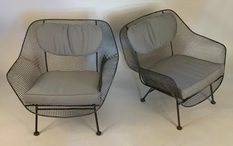 A pair of 1950s 'Sculptura' wrought iron lounge chairs designed by Russell Woodard.

Woodard's Sculptura collection was made with wrought iron frames and woven steel mesh seats. These are the largest and most comfortable lounge chairs made by
