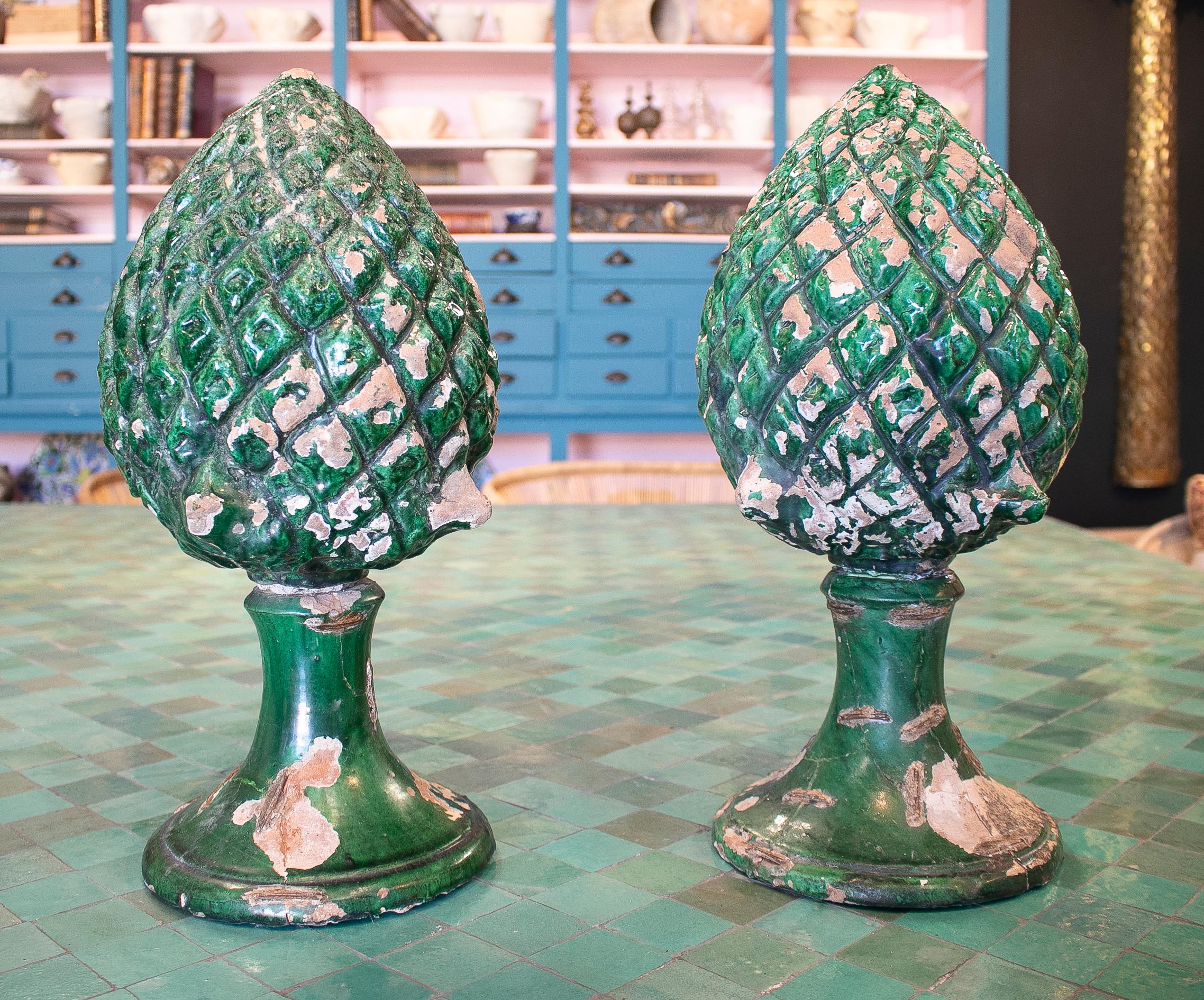 Pair of 1950s Spanish green glazed pine cone terracotta finials. 


 