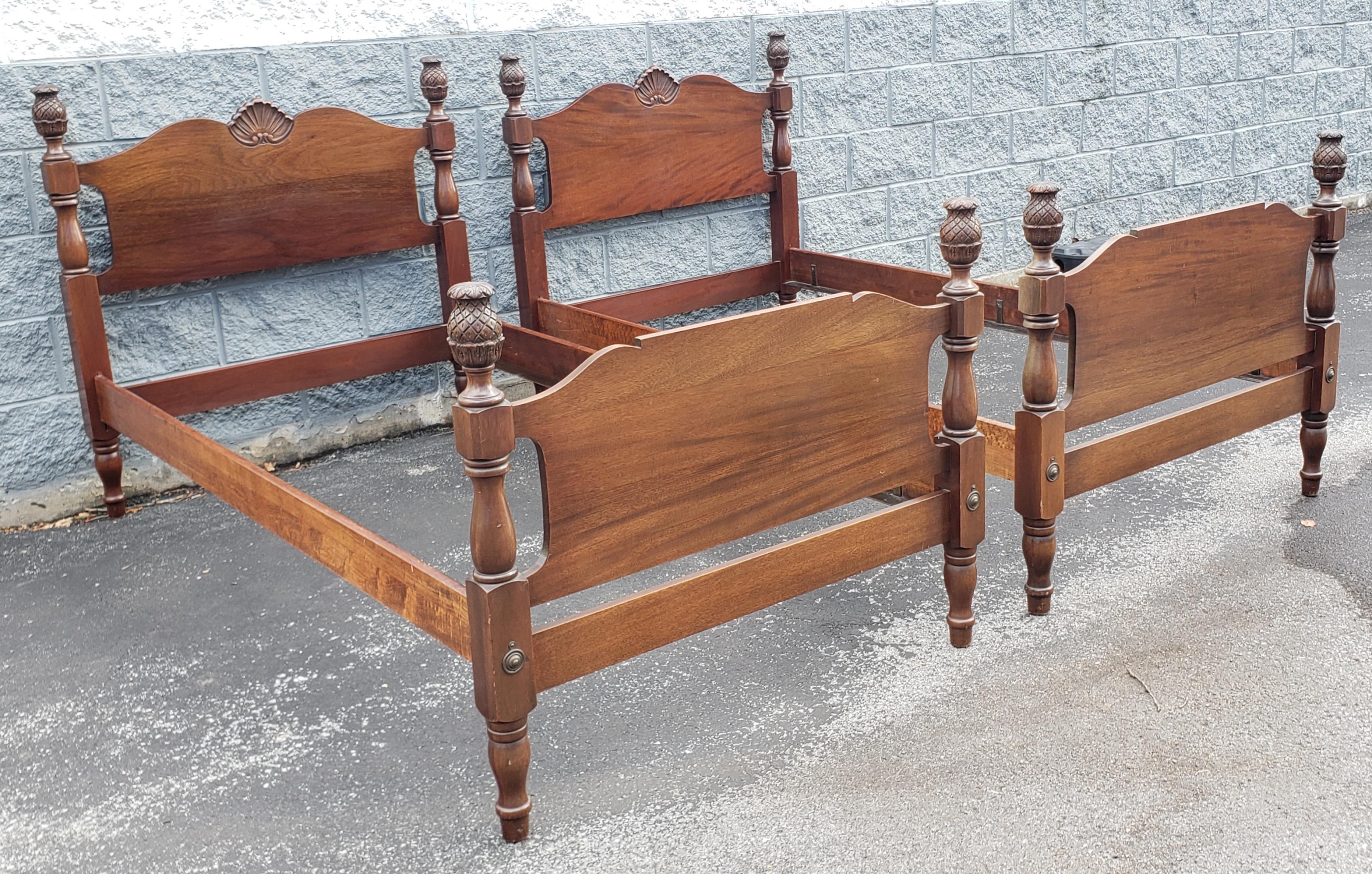 Pair of 1950s Staton Trutype Certified Genuine Mahogany Pineaple Twin Size Beds in very good vintage condition. Superior craftmanship with patented bed rails with wood and iron.  Has been refinished a few year ago. Measures 81.5