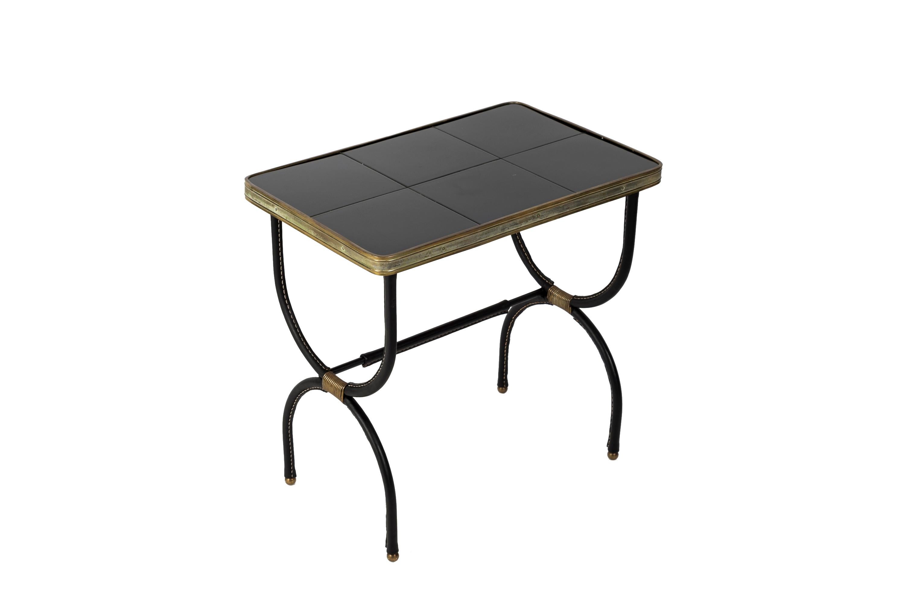 Rare pair of side tables in stitched leather with a black ceramic top
France
1950's
