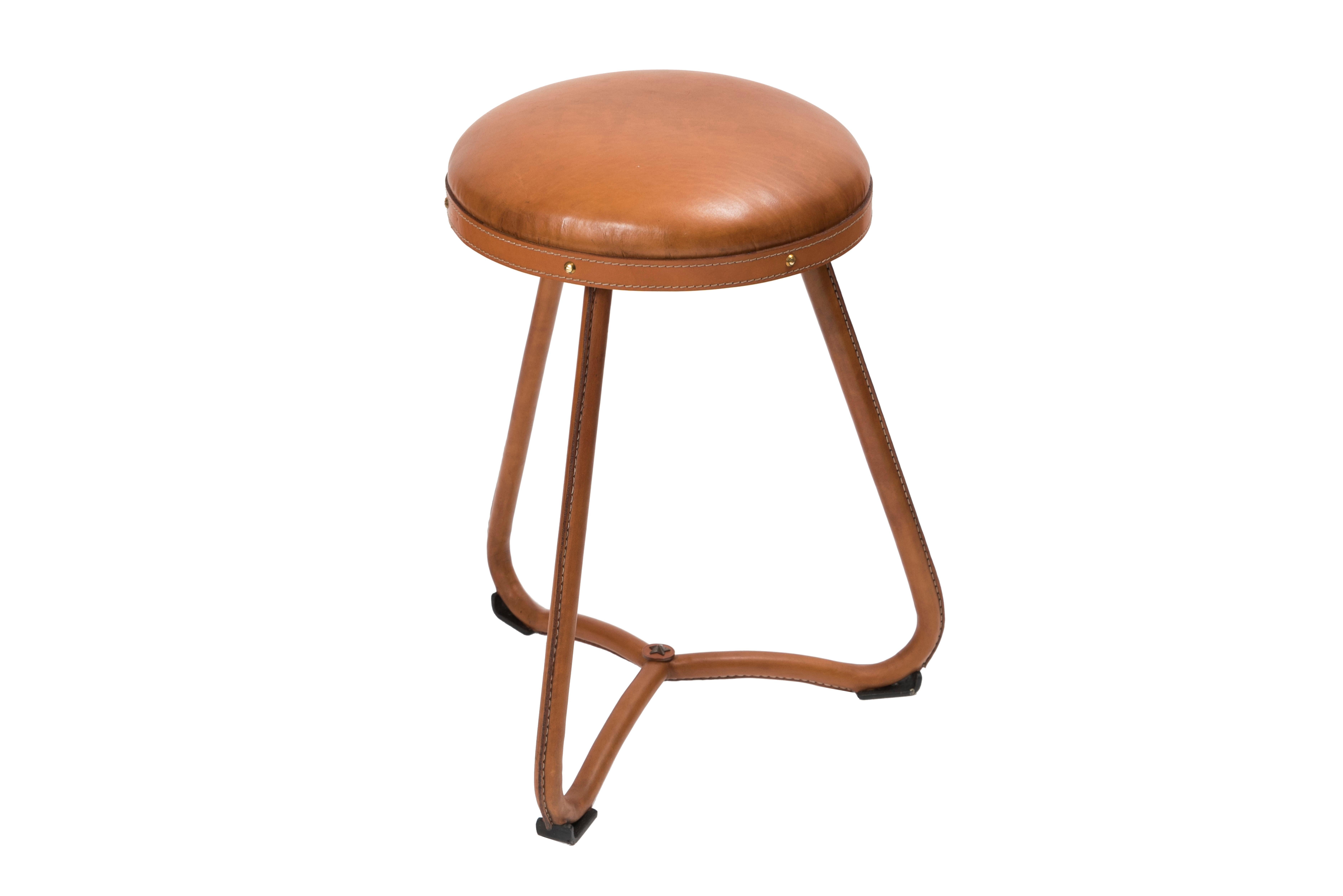 1950ss stitched leather pair of stools by Jacques Adnet,
France.