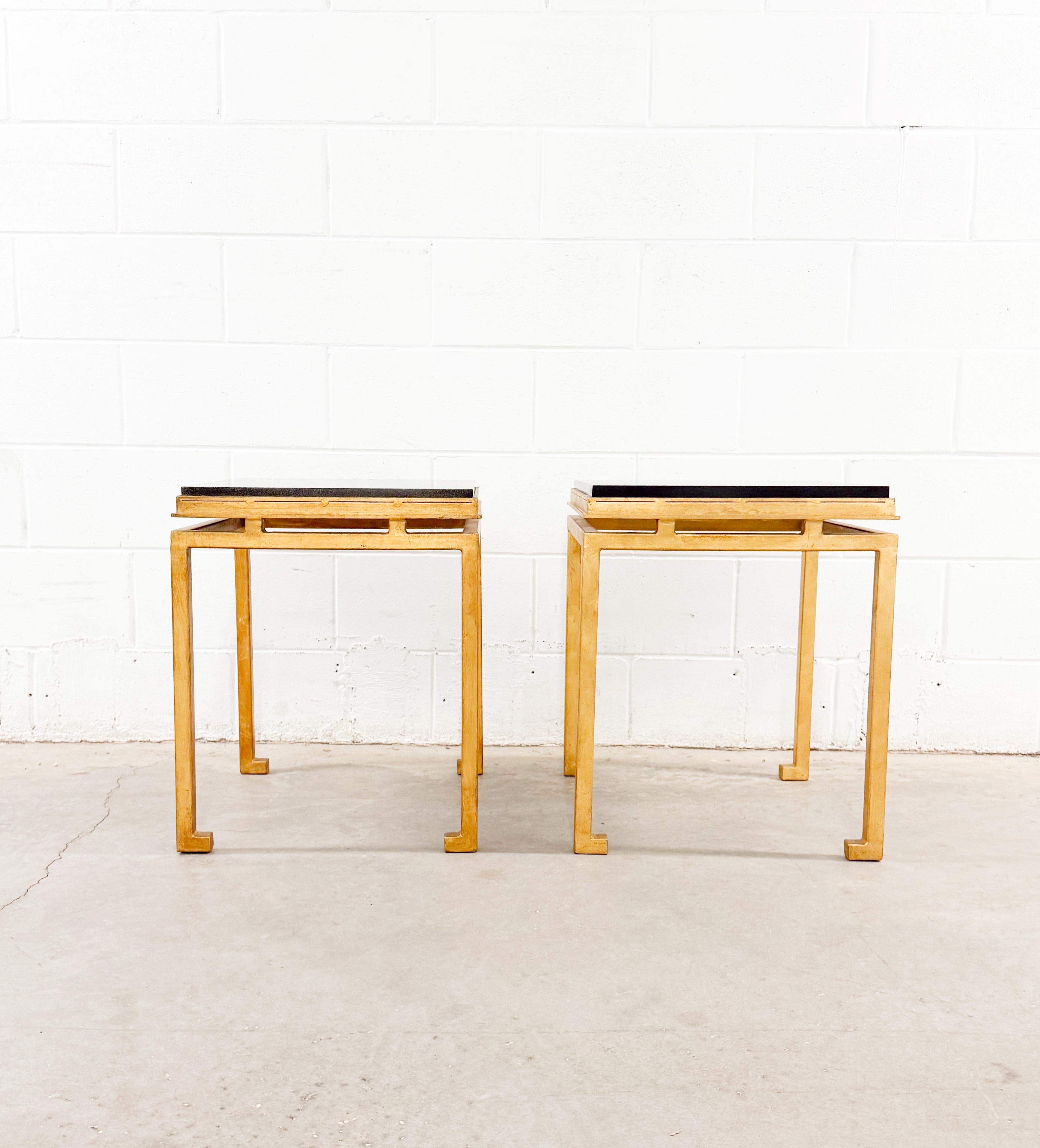 Stunning pair of French-style mid-century modern side tables attributed to Maison Ramsay. The tables are unmarked but display Ramsay's signature silhouette features, including turned-in feet and a suspended top. Made of gilt wrought iron with a