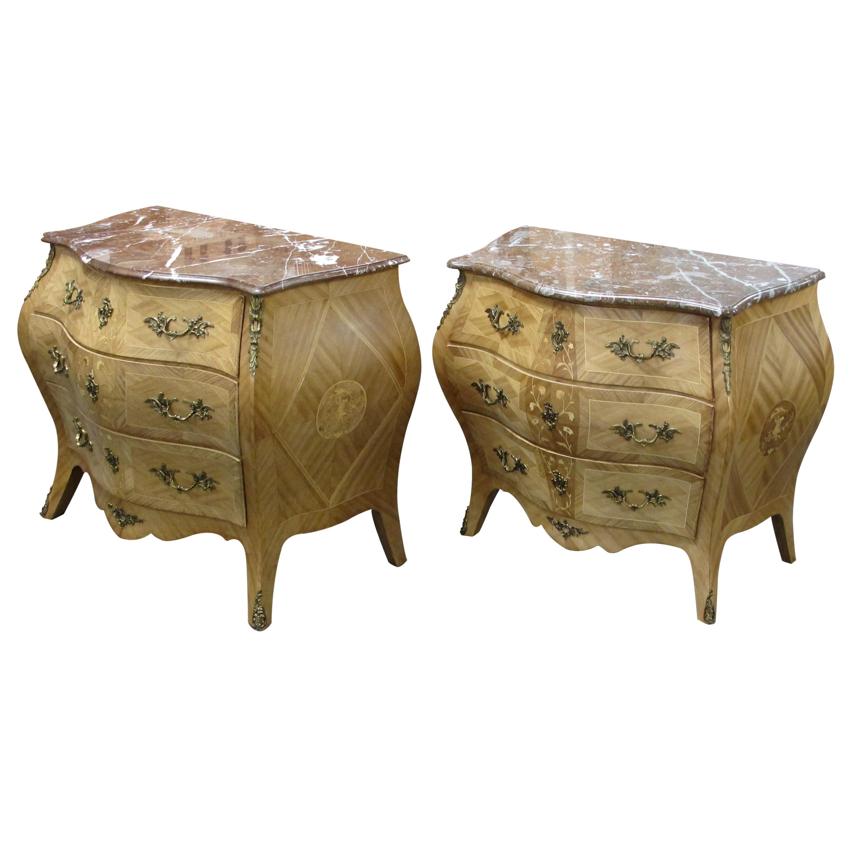 A splendid pair of chests of drawers/commodes which are very well-made Swedish furniture pieces and feature marquetry that showcases an elegant inlay leafy design, all crowned with beautiful marble tops. While these bombe chests are undeniably
