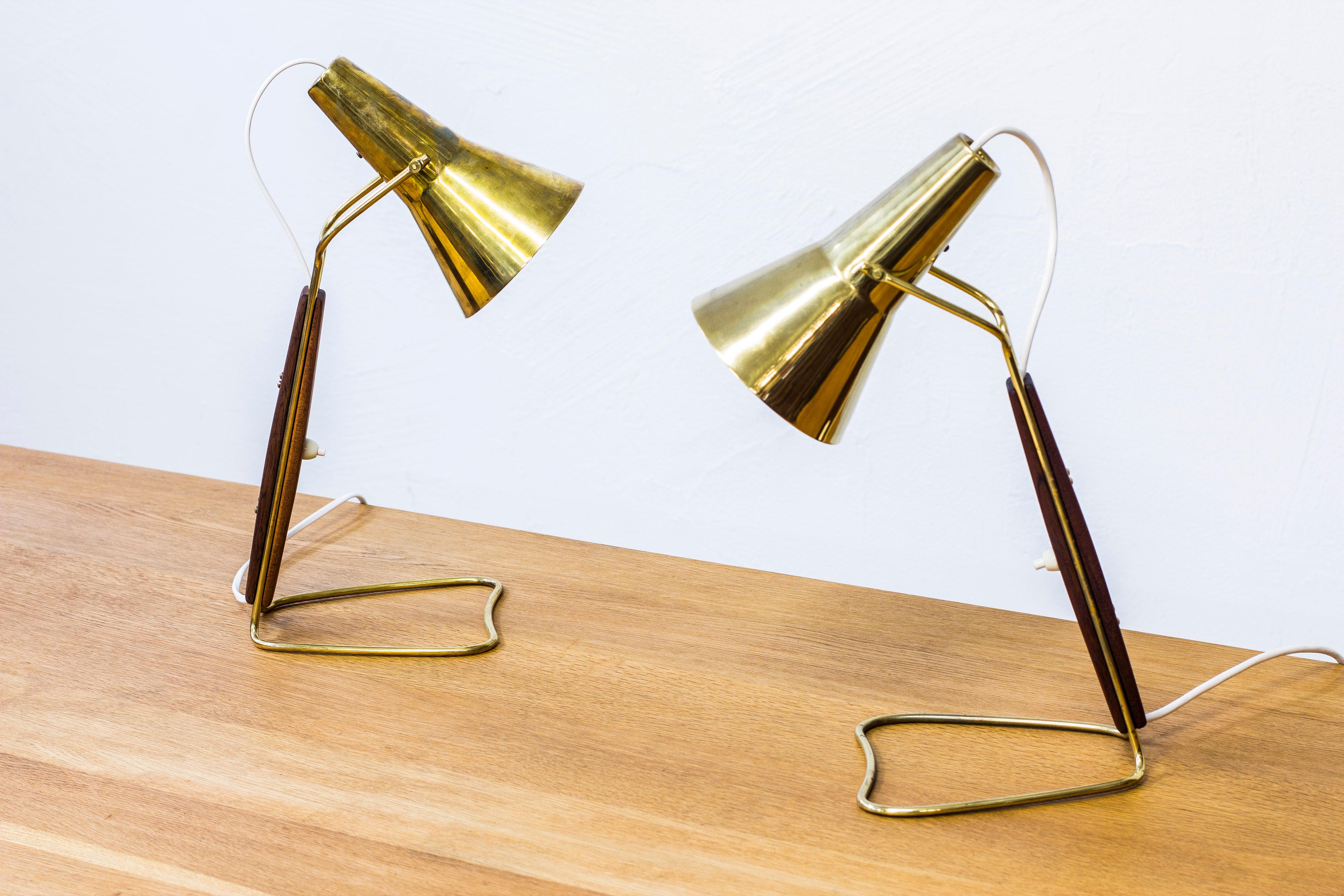 Pair of rare table lamps produced by ASEA in Sweden. Attributed to Hans Bergström. Made from polished brass and solid mahogany. Light switch on the lamps in working condition. New electric cables. Very good condition with few signs of wear and light