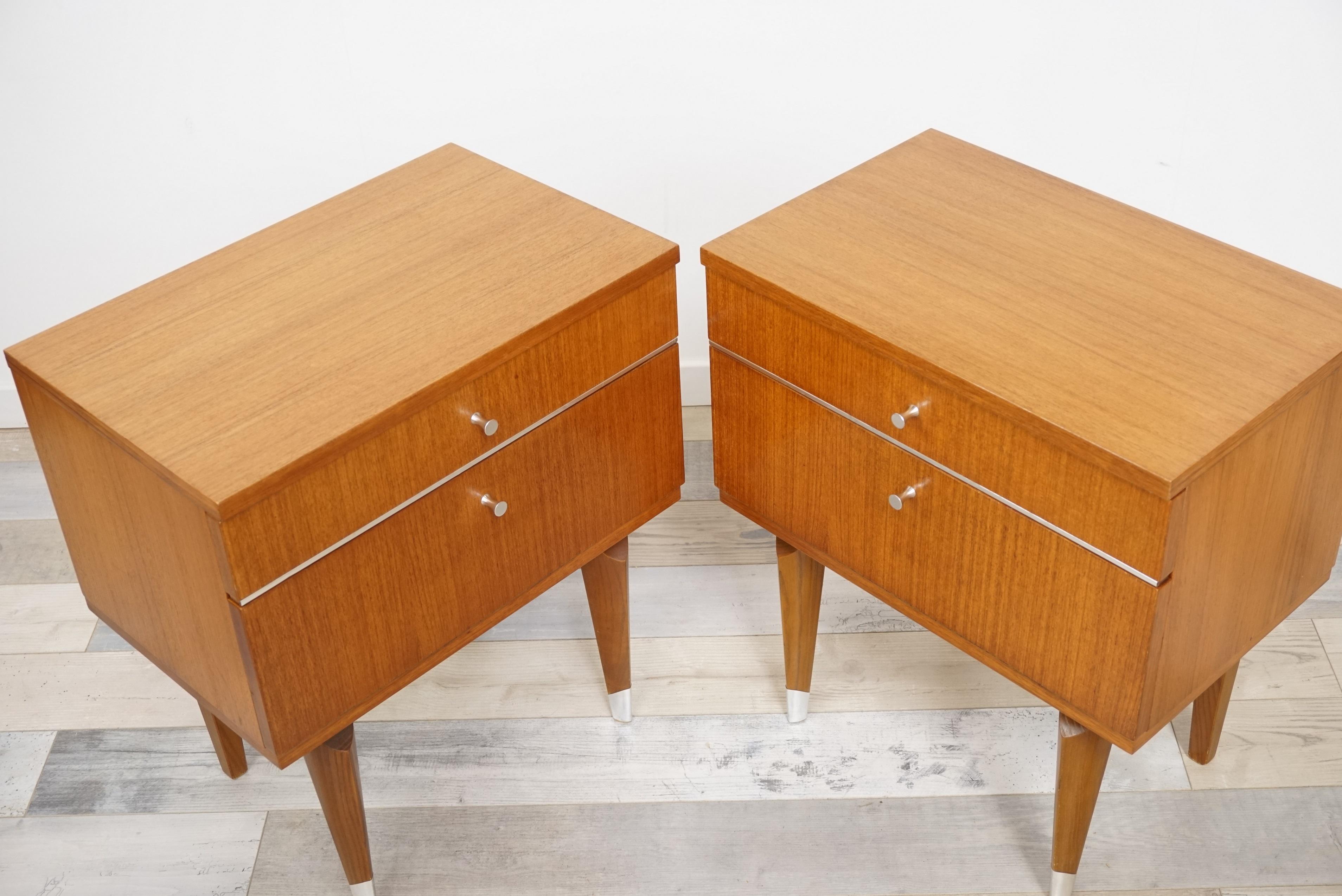 Pair of 1950s design bedside tables in teak, chromed handles and chromed edging, square feet chromed finished, one drawer with an opening in front by flap... All in excellent condition!