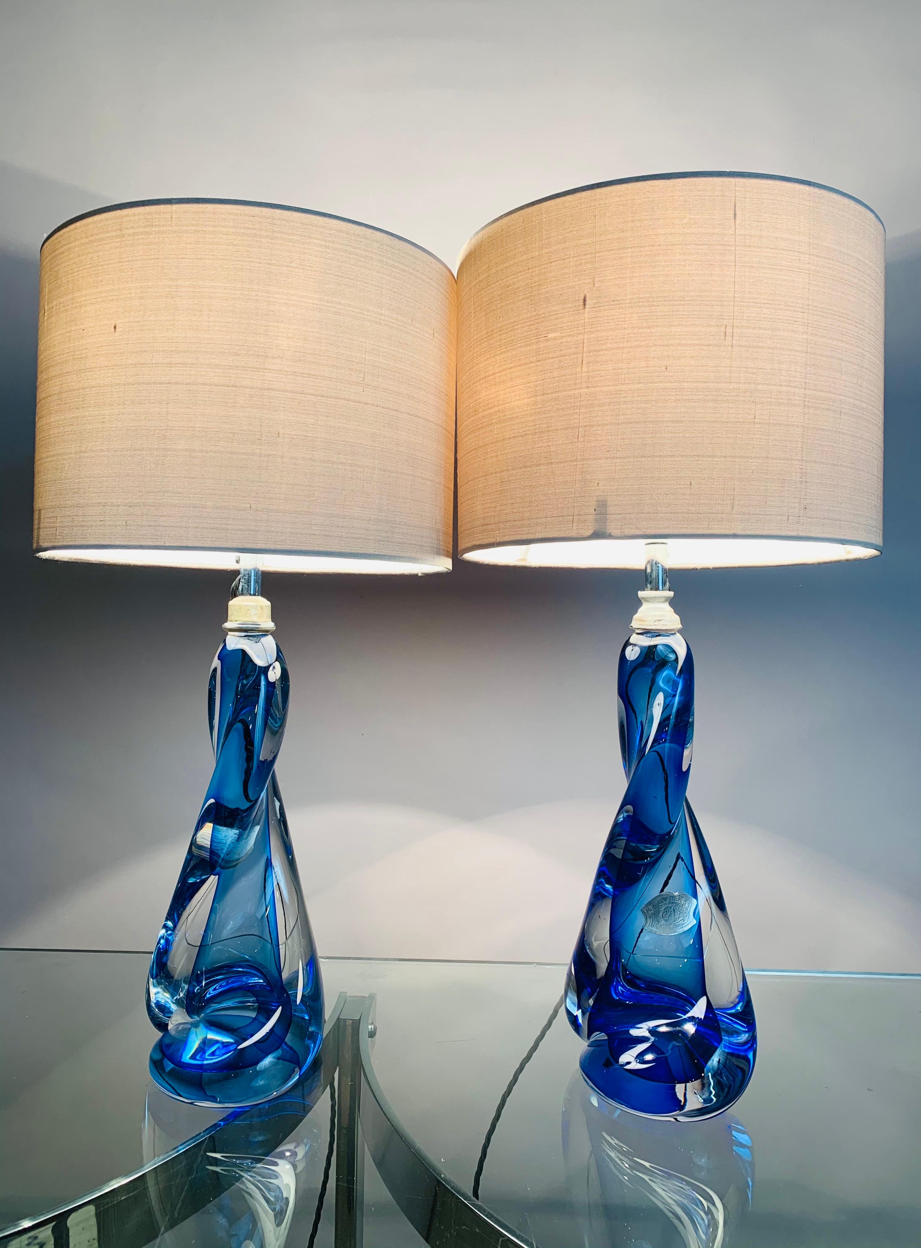 Pair of 1950s, Val St Lambert, blue and clear glass, twisted crystal lamp bases with chrome mounted light fittings. Handmade in heavy lead crystal glass in Belgium. The brand new grey silk shades are included. The lamps still bear their original Val