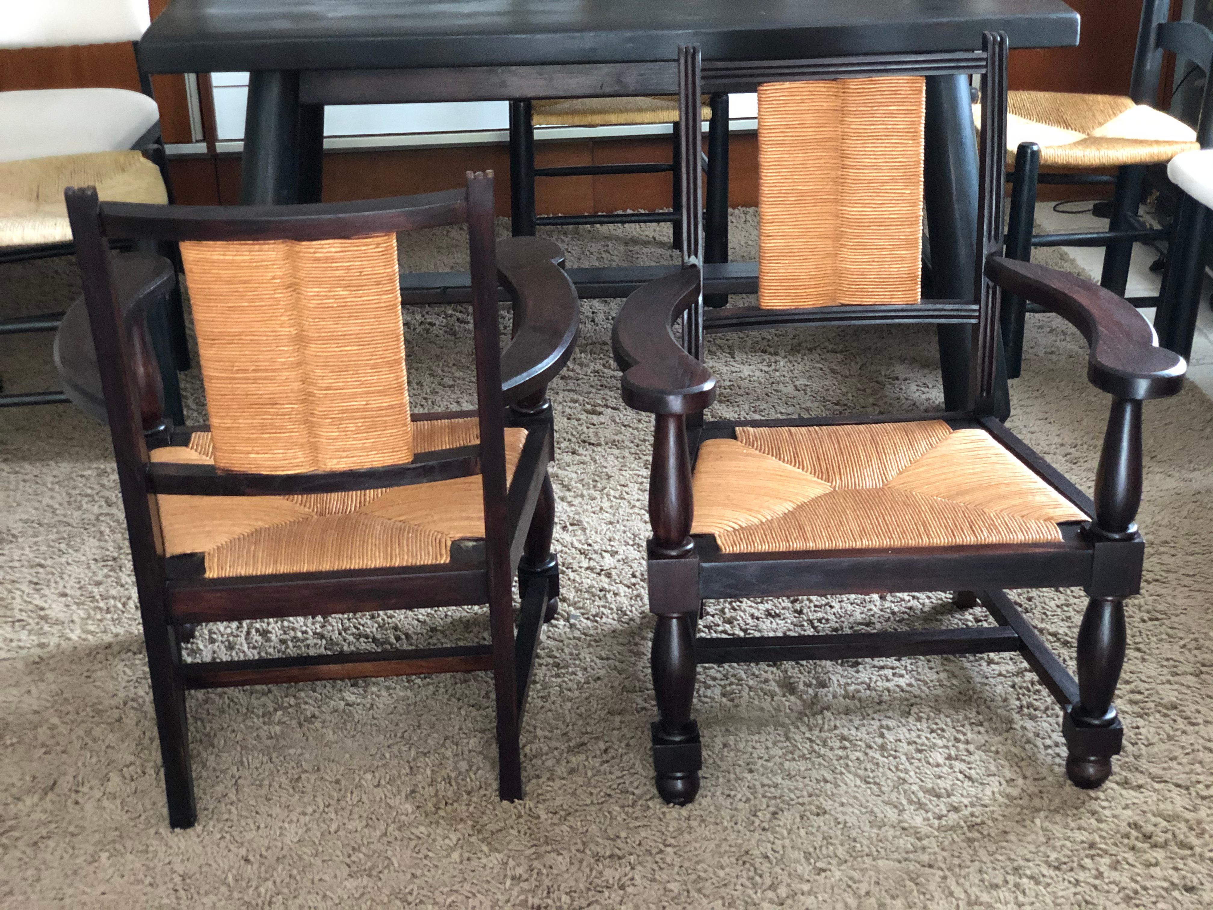 Pair of 1950s neo-basque vintage oak armchairs, straw-covered seats and backs. Fully restored. Dimensions: Height: 83 cm. Width: 53 cm. Depth: 63 cm.