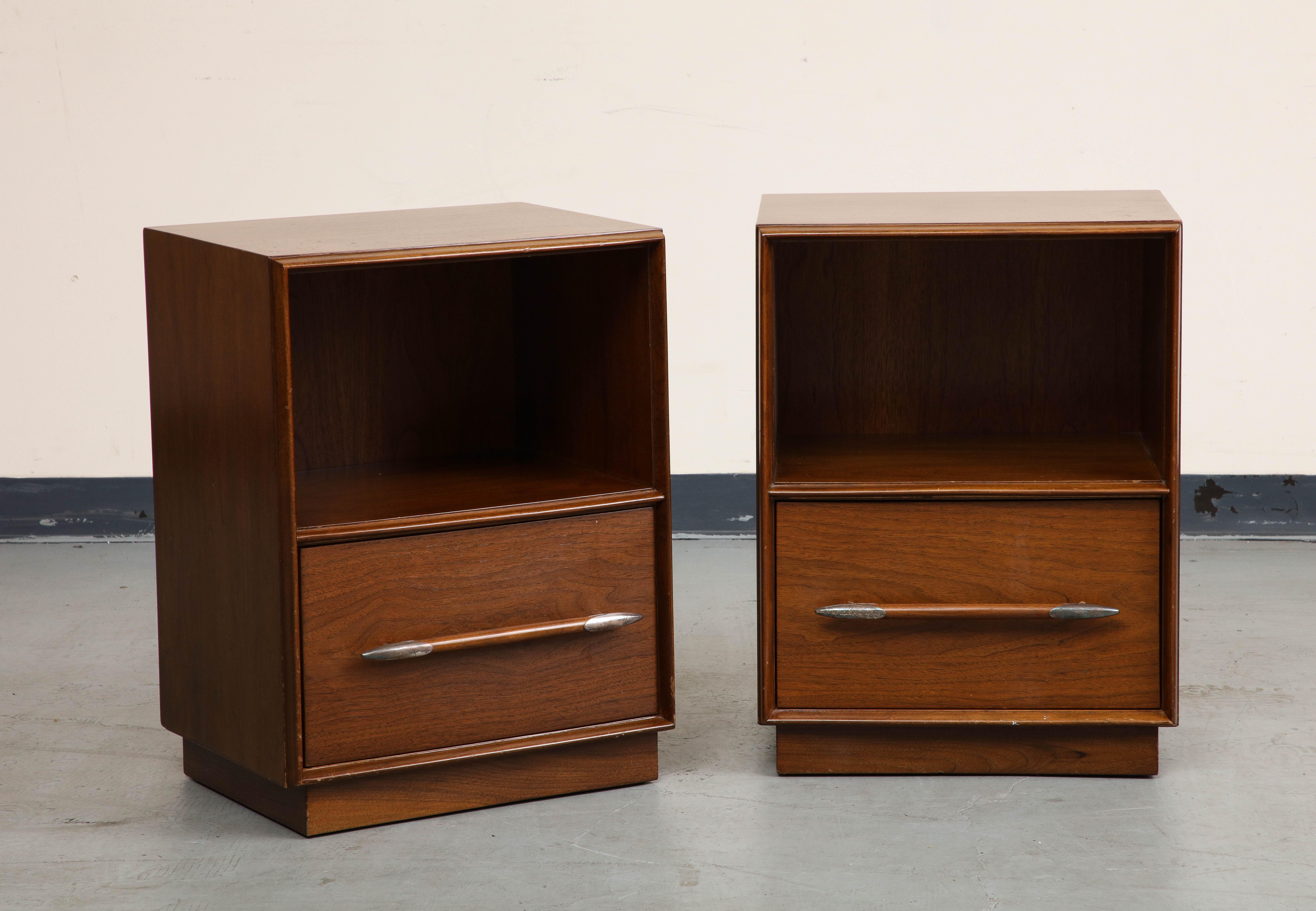 Pair of 1950s Walnut Nightstands or End Tables, featuring one drawer with silvered spear shaped handles and an open upper compartment for storage. 

Classic midcentury design by T.H. Robsjohn-Gibbings for The Widdicomb Furniture Company.