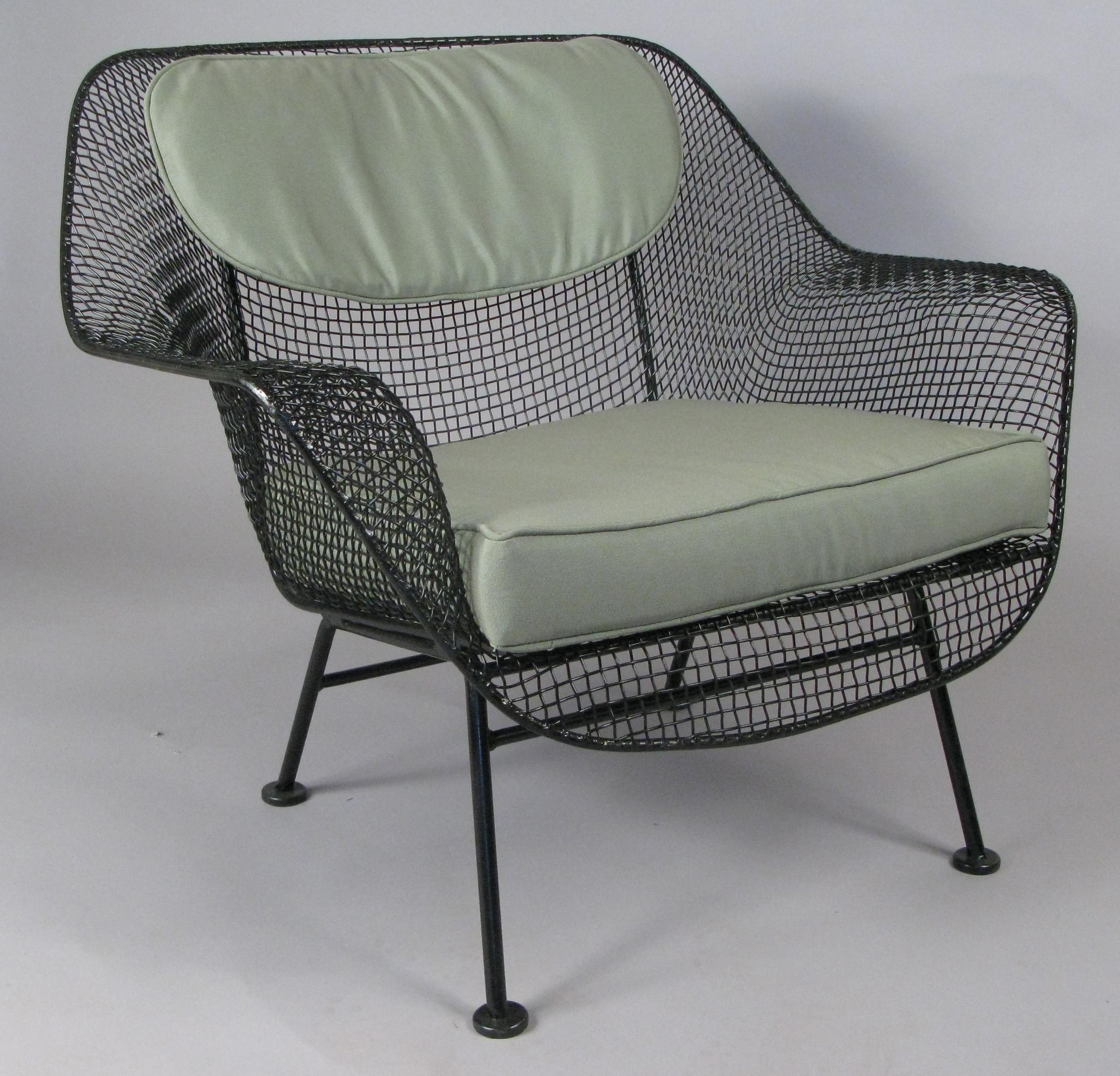 A pair of 1950s 'Sculptura' garden lounge chairs designed by Russell Woodard. 

Woodard's Sculptura collection was made with wrought iron frames and woven steel mesh seats. These are the largest and most comfortable lounge chairs made by Woodard