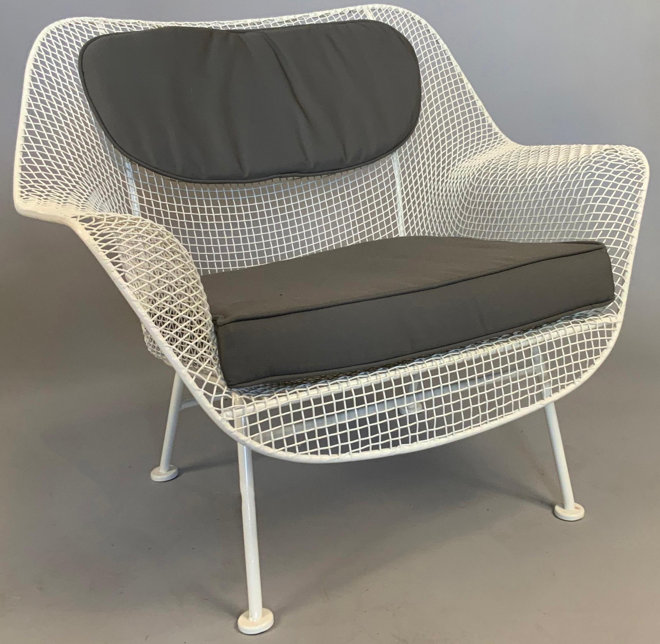 A pair of 1950s 'Sculptura' wrought iron lounge chairs designed by Russell Woodard. 

Woodard's Sculptura collection was made with wrought iron frames and woven steel mesh seats. These are the largest and most comfortable lounge chairs made by