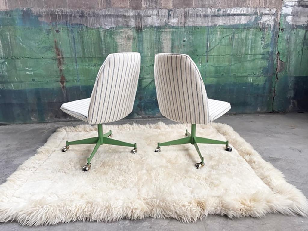 Gorgeous and incredibly unique 1960s vintage rolling chairs with metal green bases!
Nice cushioned seat and seat back, in a simple white pin striped fabric. A major conversation starter!

Price is for the Pair! 

We could see these being