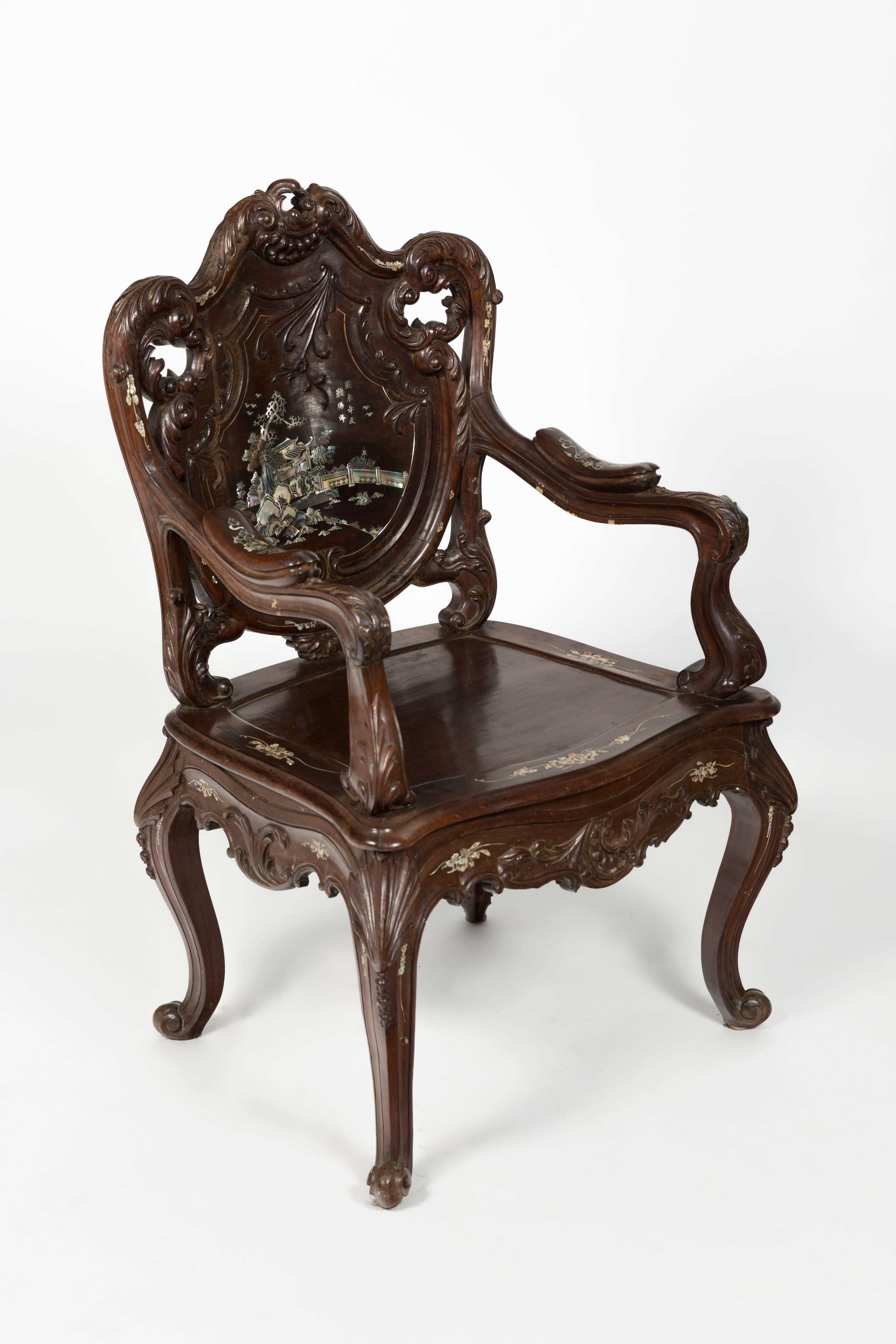 Pair of highly carved rosewood chairs with mother-of-pearl inlay. Mother-of-pearl inlay on the back and front of chair.

 
