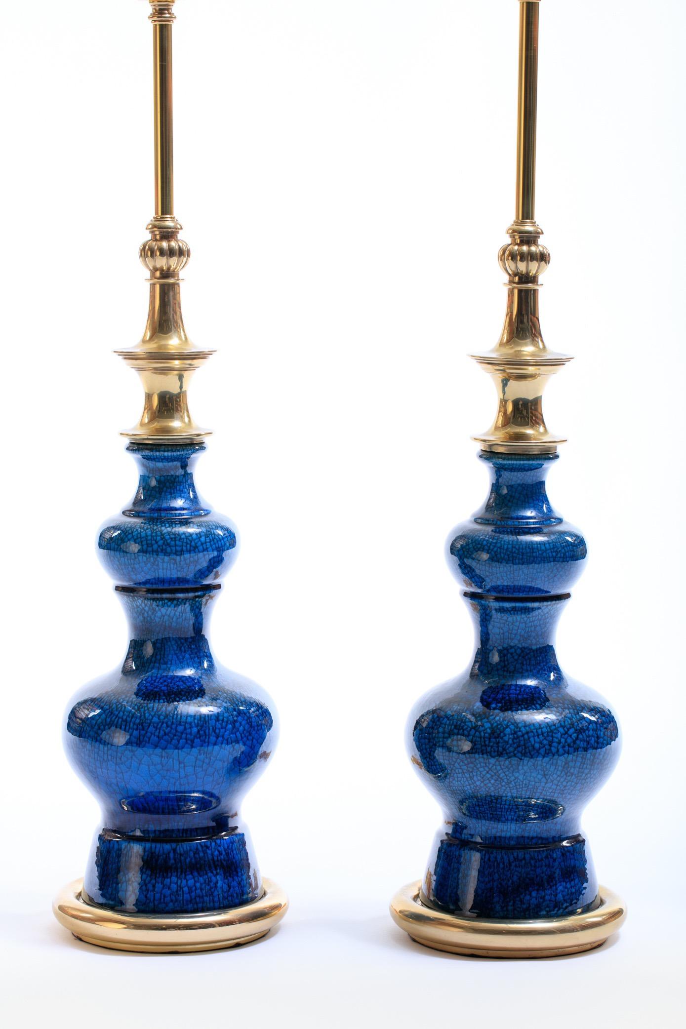 Pair of 1960s lamps with ceramic gourd forms and brass fittings. Deep cobalt blue crackle glaze. Note white reflections of lights in photos are not loses to the finish but instead the reflection of studio lights in the images. The lamps would work