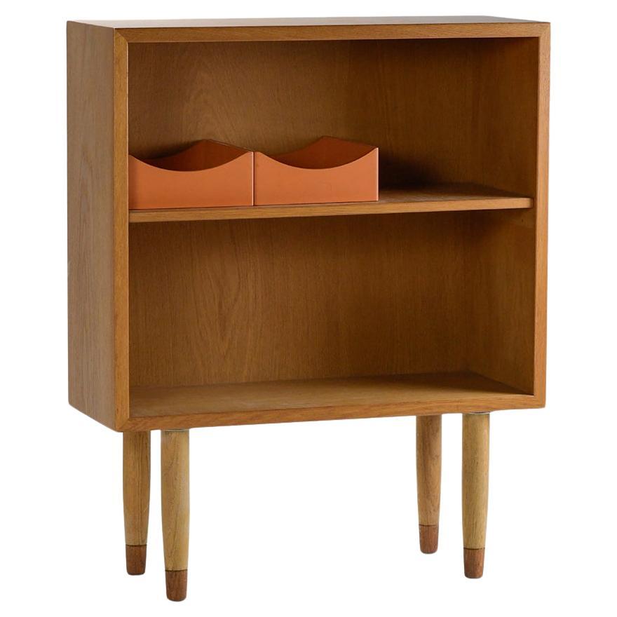 Pair of bookcases by Borge Mogensen for Karl Andersson and Soner. The pair is in good restored condition, one of the cases being slightly darker than other other and one has two small scratches on the top. The largest scratch of the two is about two