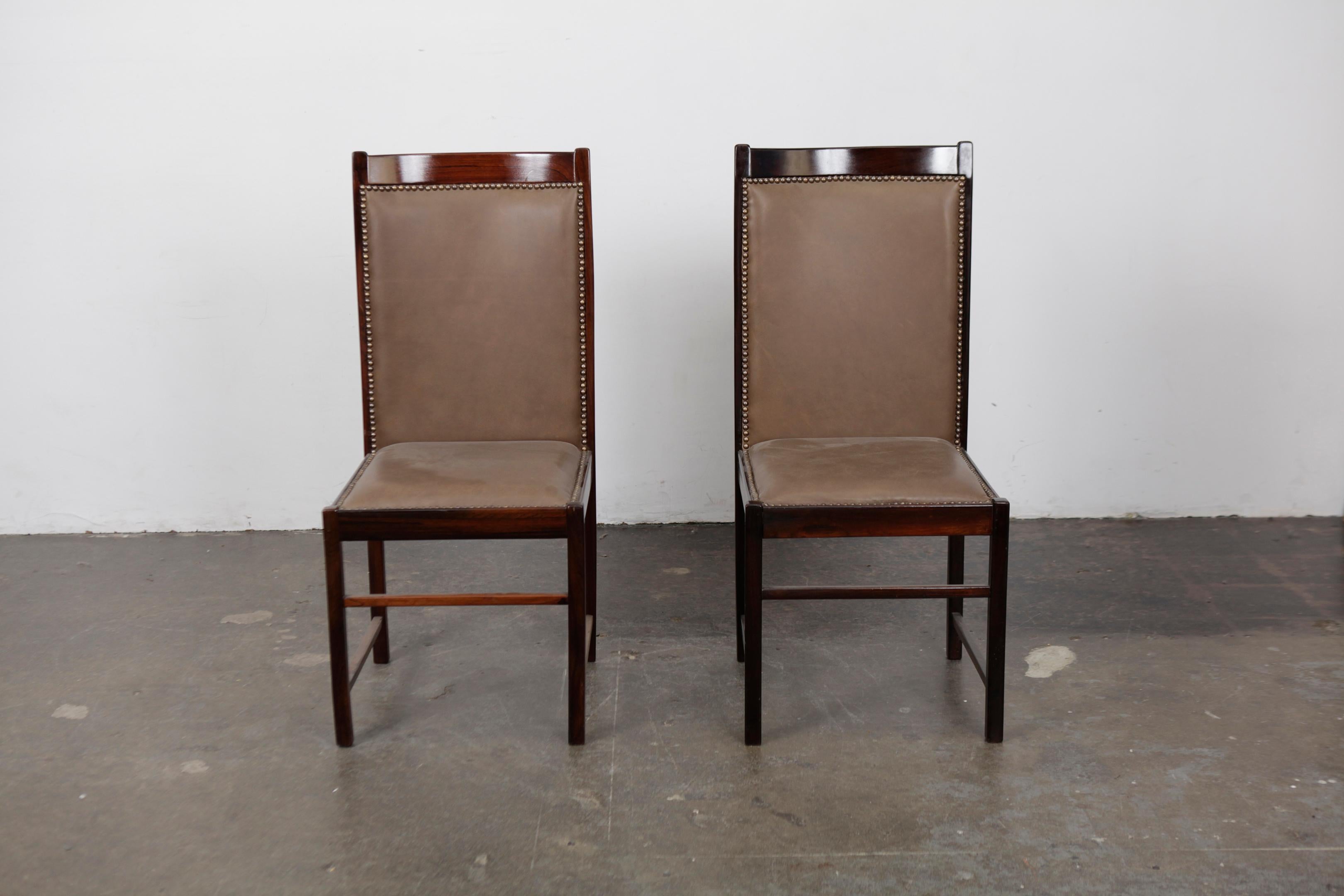 Pair of solid rosewood tall back dining chairs designed by Celina Moveis, Brazil, 1960s Newly upholstered in brown leather. Very elegant tall back dining chairs.