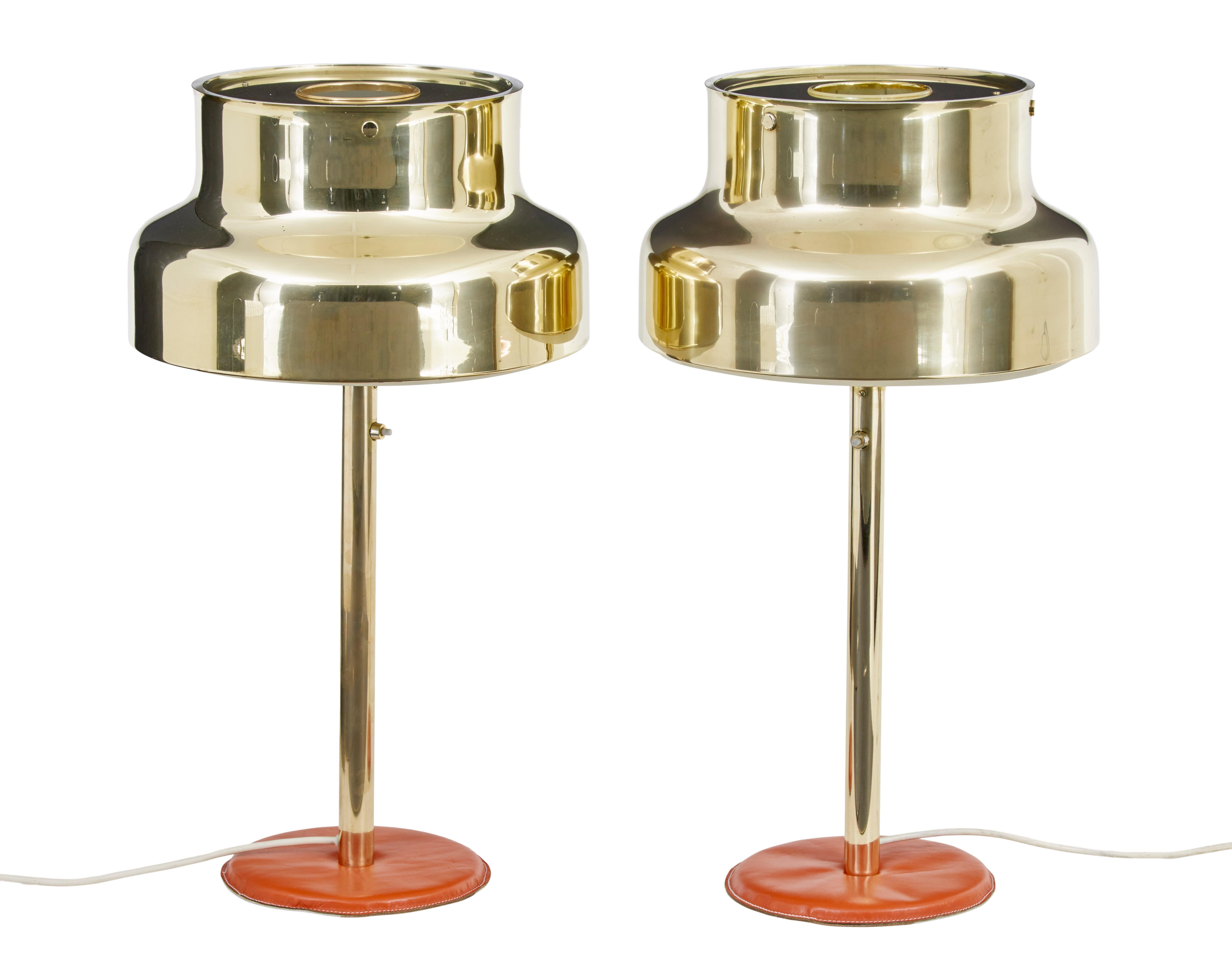 Stunning piece of design with these well known 'bumling' design lamps by Anders Pehrson for Atelje Kyktan. Shades in brass which unlike most examples online retain their original brass tops. Brass column with leather base.

Complete with underside