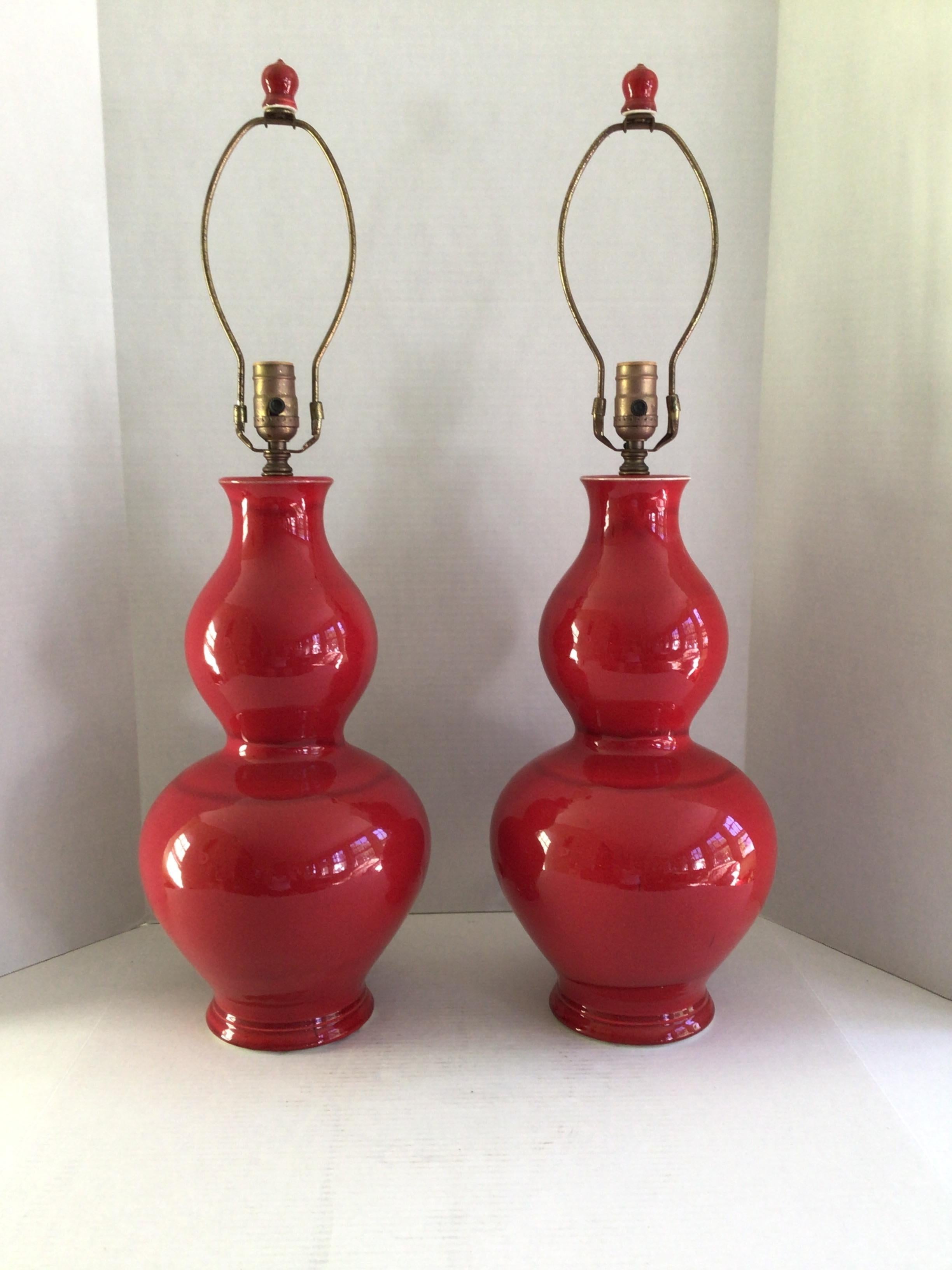 Add a bright accent to any space with this Pair of 1960s Candy Apple Red Table Lamps With Red Finials
Height to finial: 30.5” 
Height to socket; 22.5”
Needs Rewiring