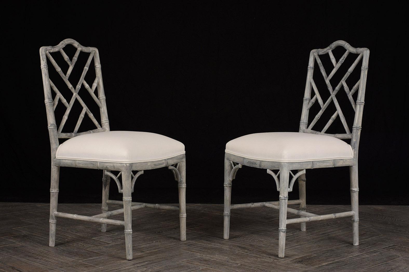 Two 1960s side chairs. Frames are carved with a bamboo-like design. The chairs have been newly painted in a pale gray color with a distressed finish. Seats have been professionally upholstered in a smooth comfortable off-white Belgium linen fabric