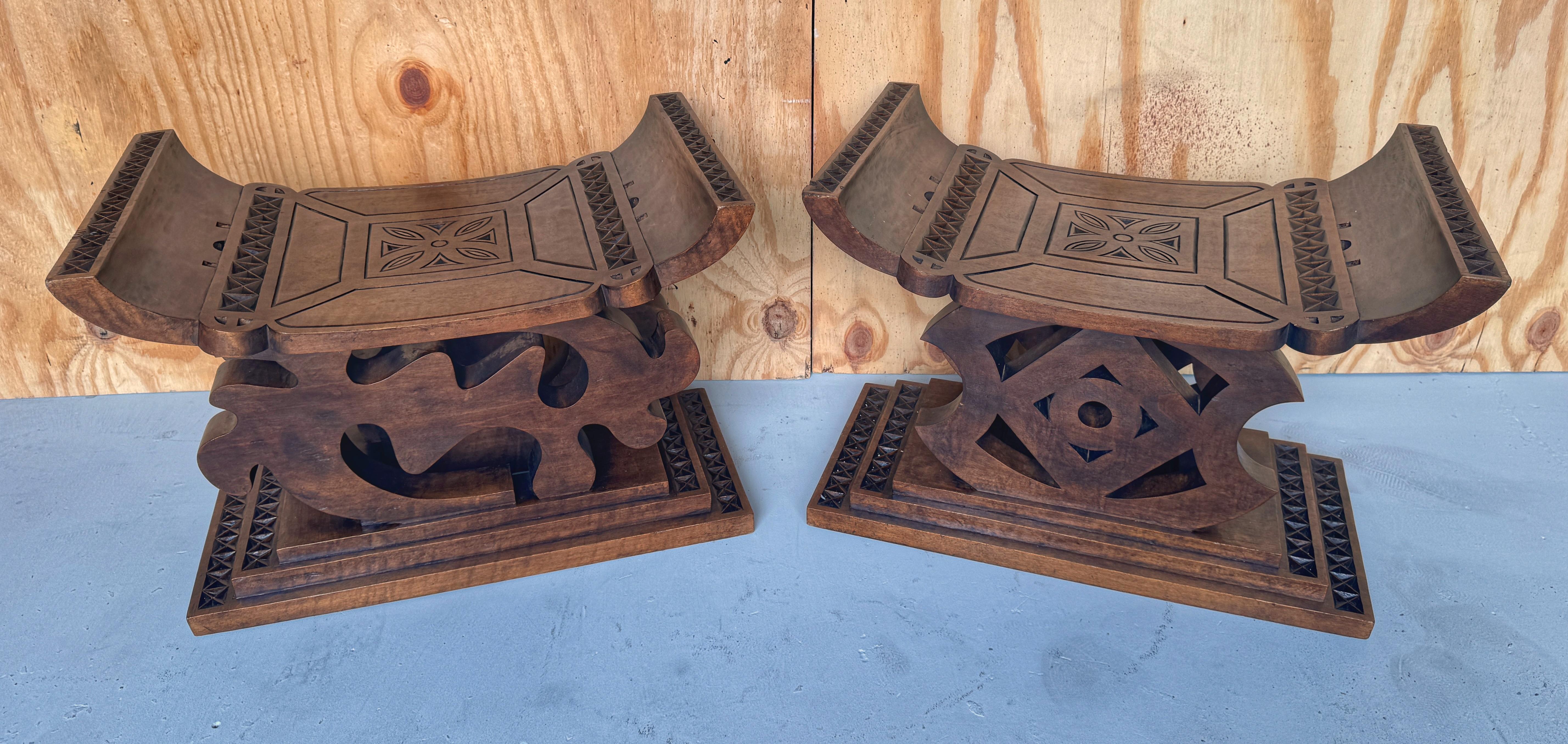 Pair of 1960s Carved Hardwood African Ghanaian Tribal Benches 
A unique pair of 1960s Carved Hardwood African Ghanaian Tribal Benches, each a testament to traditional Ghanaian craftsmanship. These carved wood stools showcase the classic Ghanaian