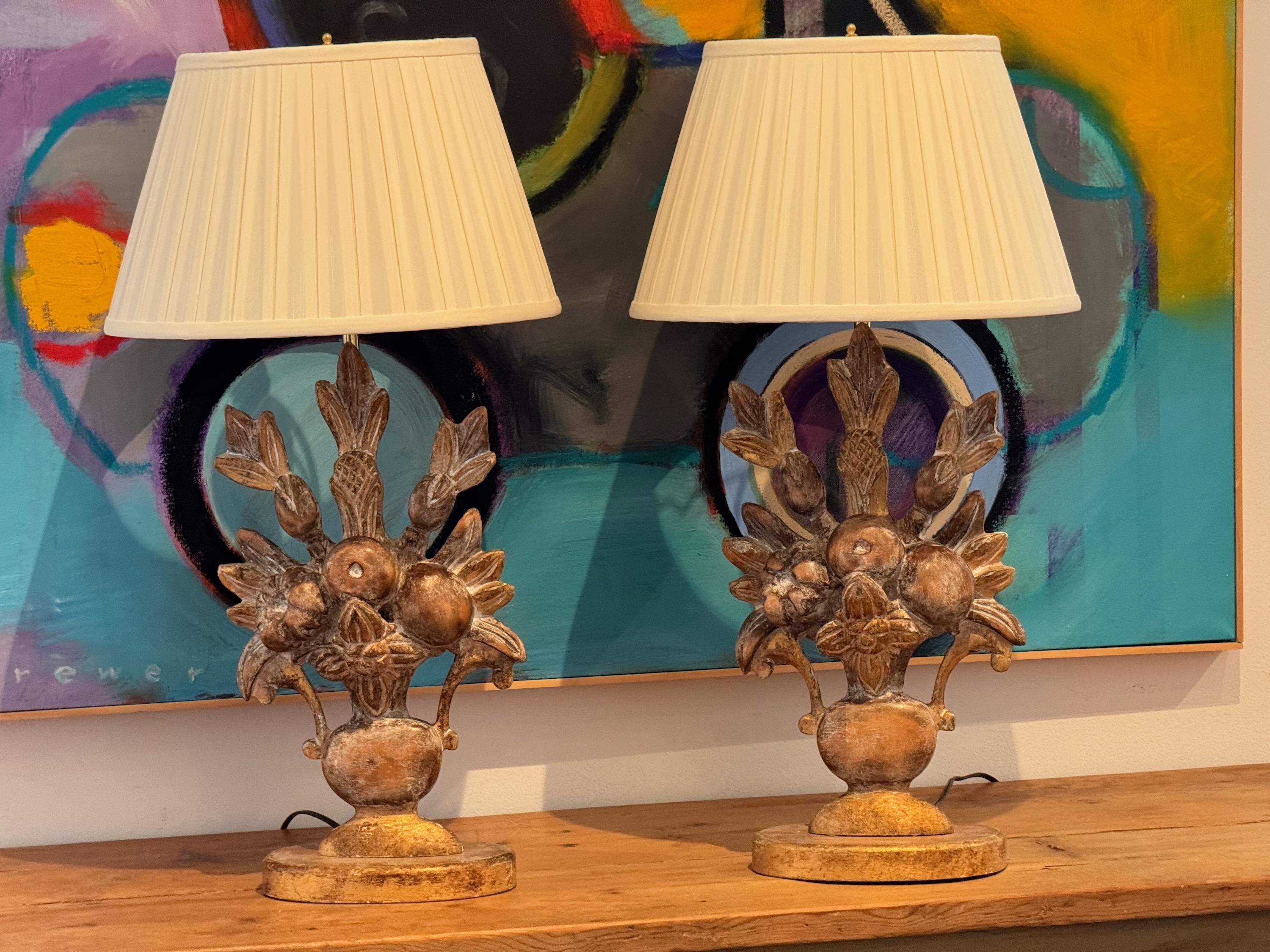 A pair of carved wood lamps. Showing gilt decoration.