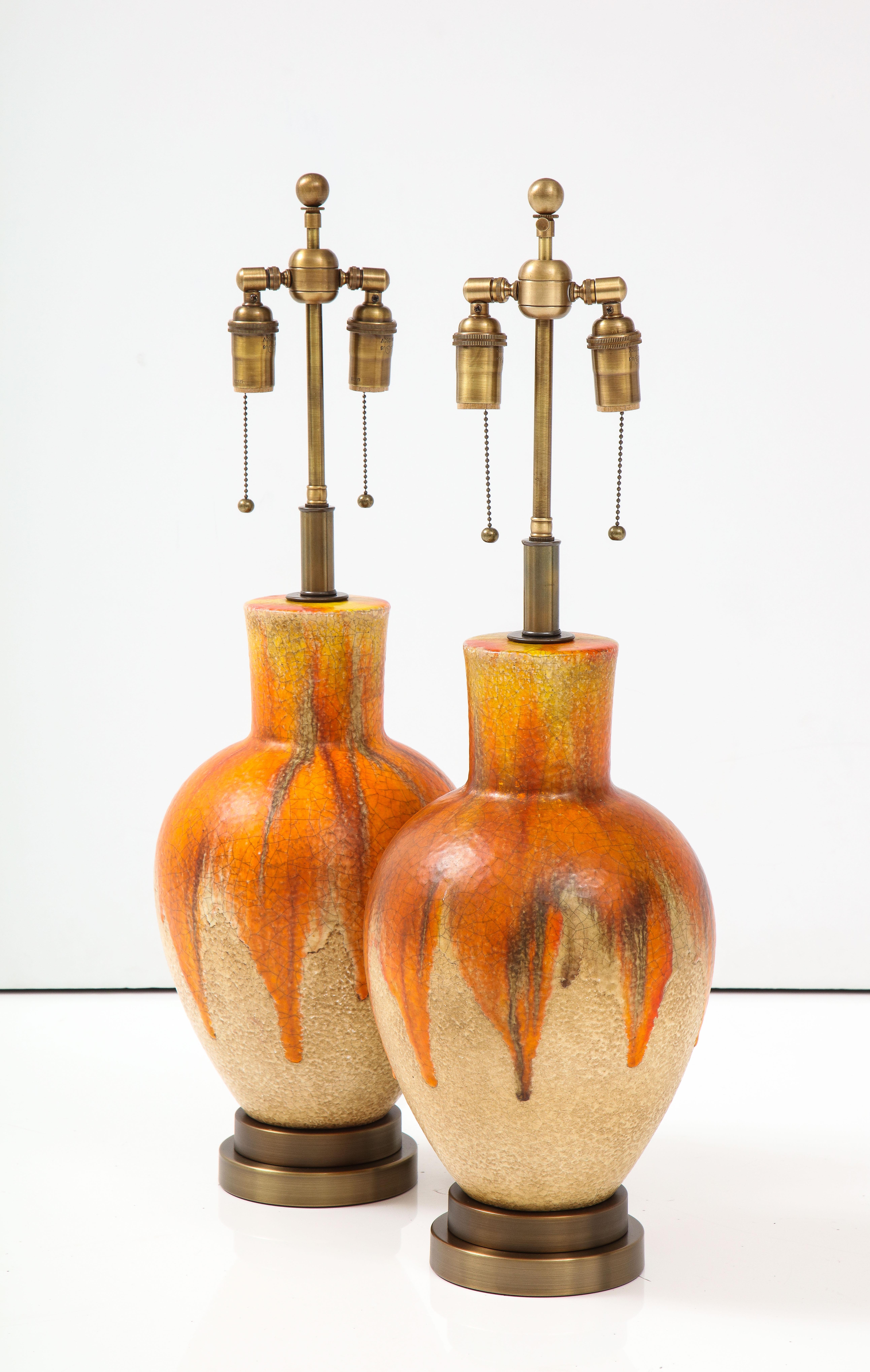 Pair of 1960's drip glazed ceramic lamps.
The ceramic lamps have a lovely textured glazed finish and are mounted on
Bronzed colored bases.
The lamps have been Newly rewired with adjustable Antiqued Bronze double clusters and Rayon cords.
The height