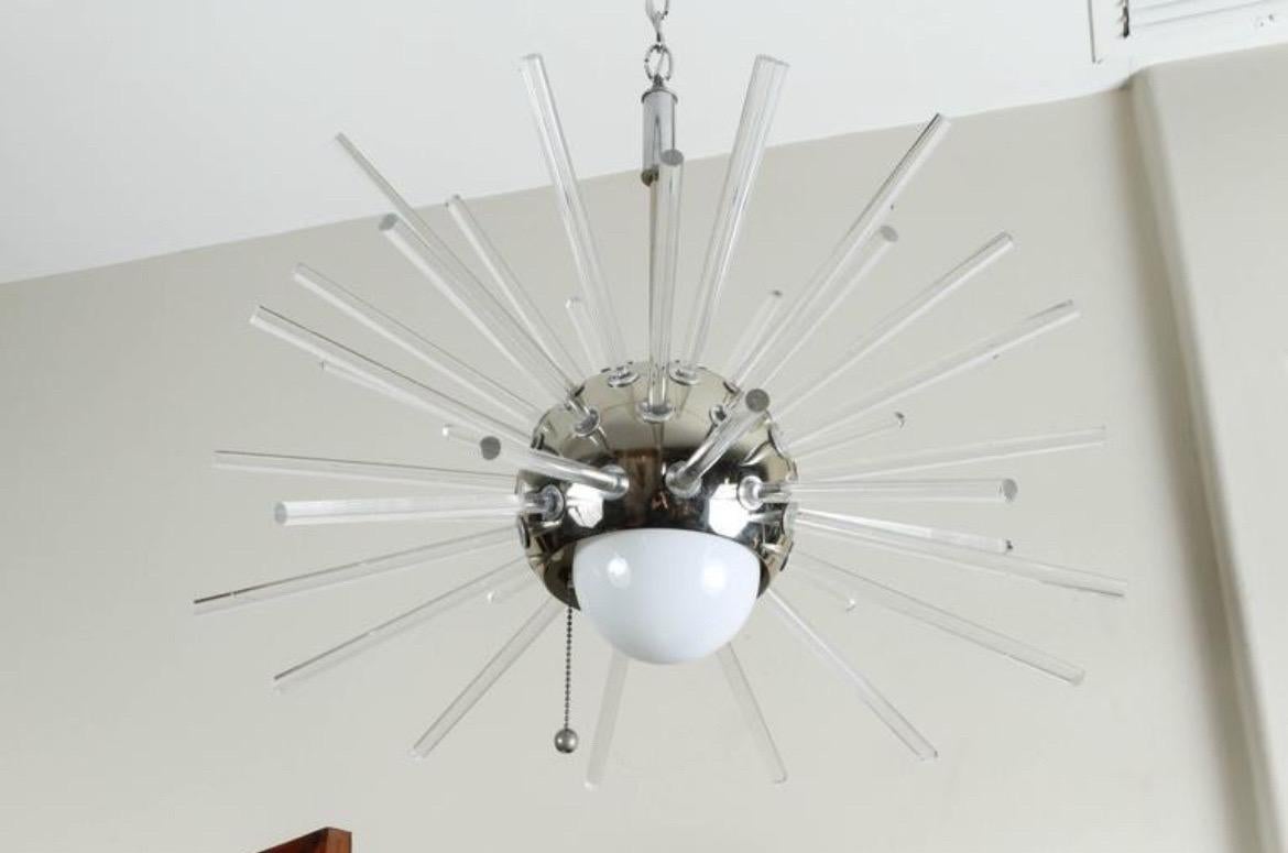 Matching pair of modernist space age sputnik pendant chandeliers.  Each light has lucite spheres coming from a polished chrome fixture.   Each pendant holds one light bulb inside (not included).  

These are currently hardwired.  See pics for