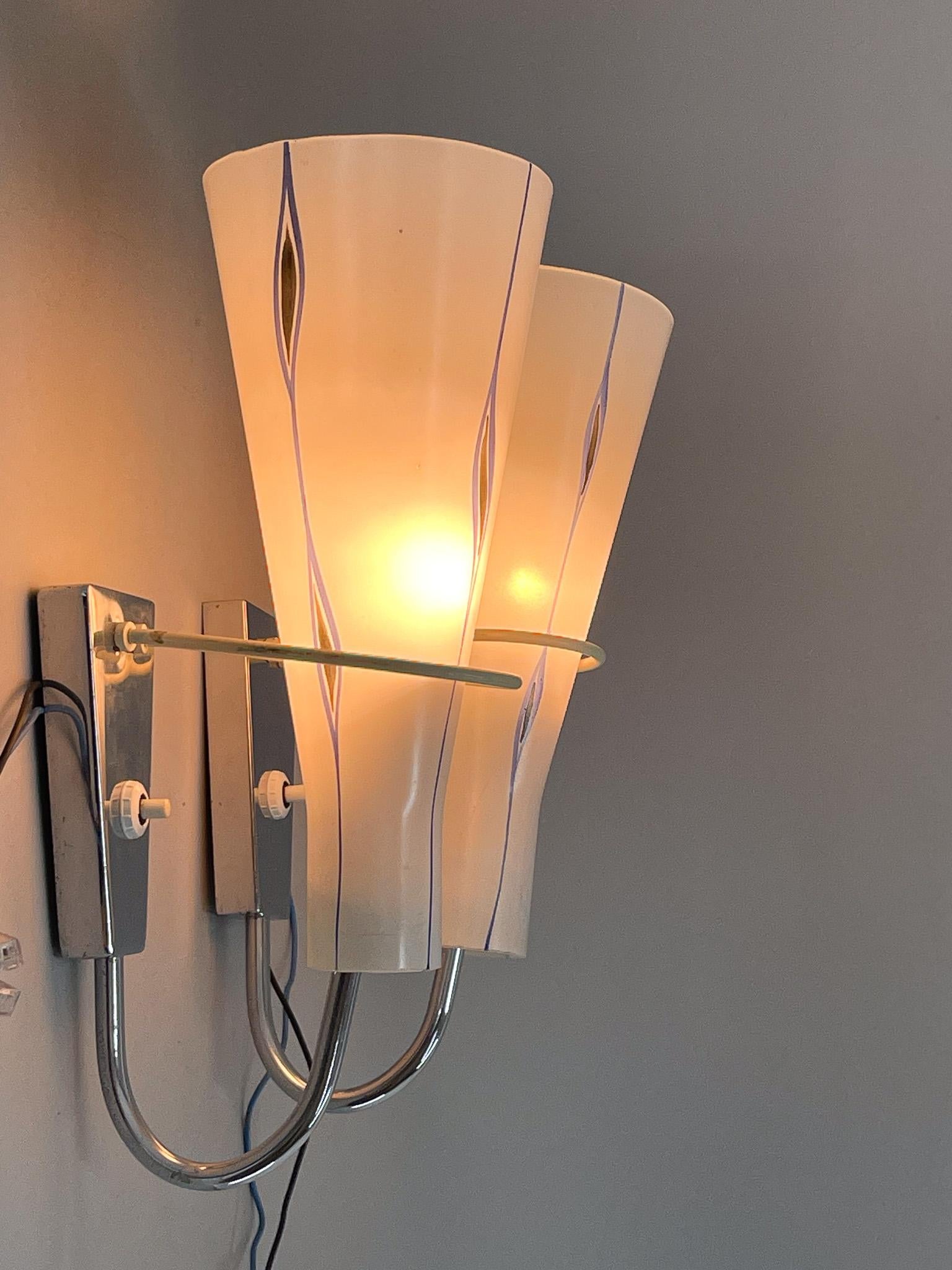 Set of two mid-century wall lights made of chrome and coloured glass. Manufactured by Zukov in former Czechoslovakia in the 1960's. 
Bulbs: 2x 1 E14. US wiring compatible.