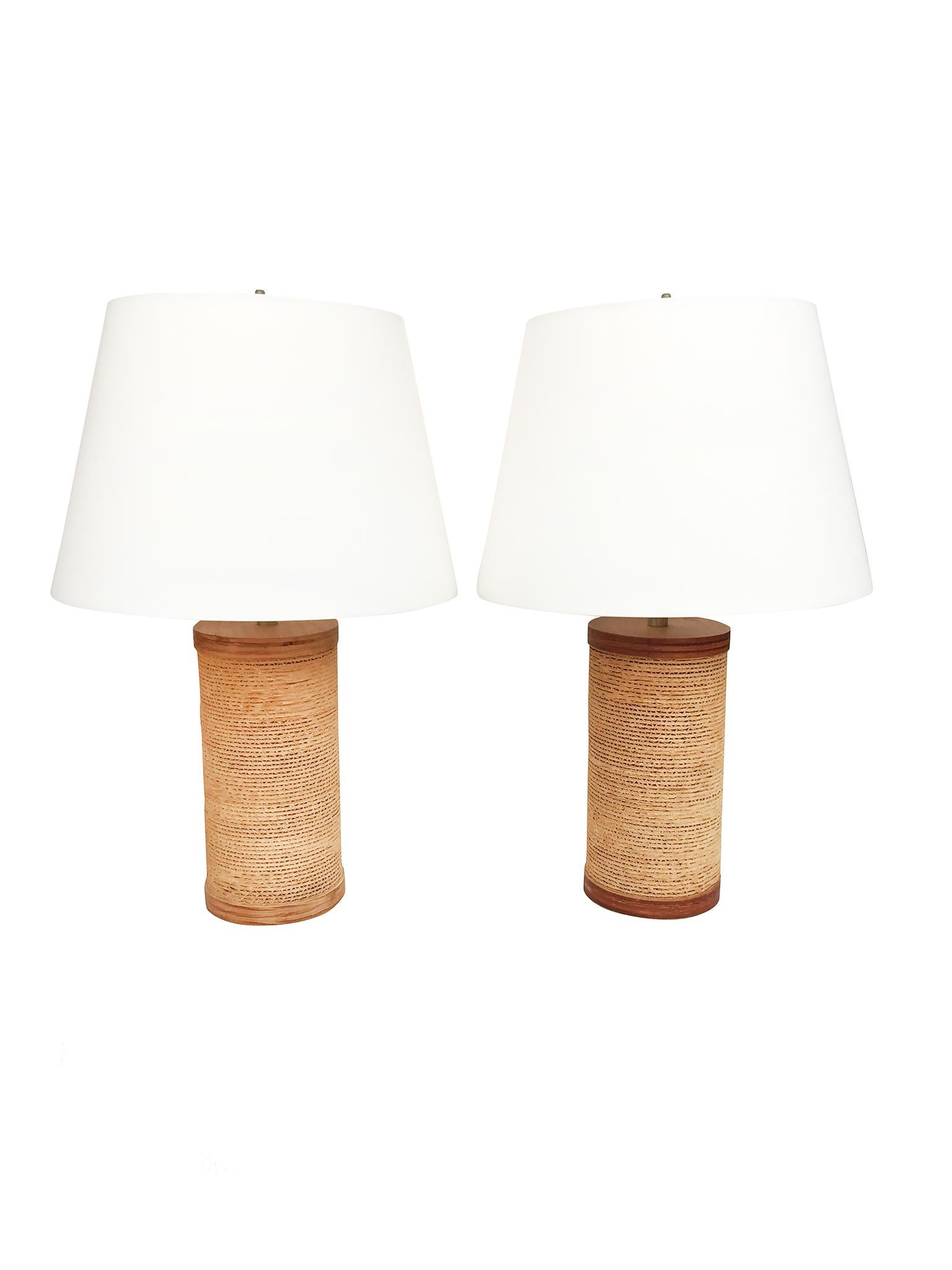 These whimsically and handsomely designed table lamps are by Gregory Van Pelt, who first designed them in the late 1960s, though it is often misattributed to Frank Gehry. The lamps are comprised of corrugated cardboard cut sleekly into a cylindrical