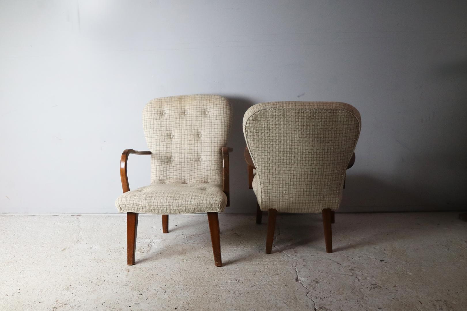 Stunning pair of midcentury chairs. The upholstery is original and in superb condition. The woolen fabric is off-white with a check pattern and button detailing. The elegant curved arms are stained beech.

Happy to sell individually.
The price