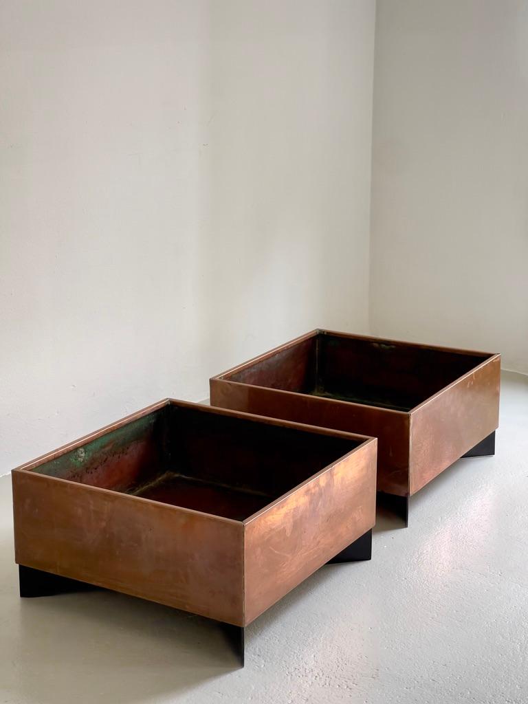 This pair of Danish modernist planters from the 1960s exemplifies the refined minimalism and architectural clarity that defined Scandinavian design of the era. Each planter consists of a crisply constructed cross-shaped steel base, finished in matte