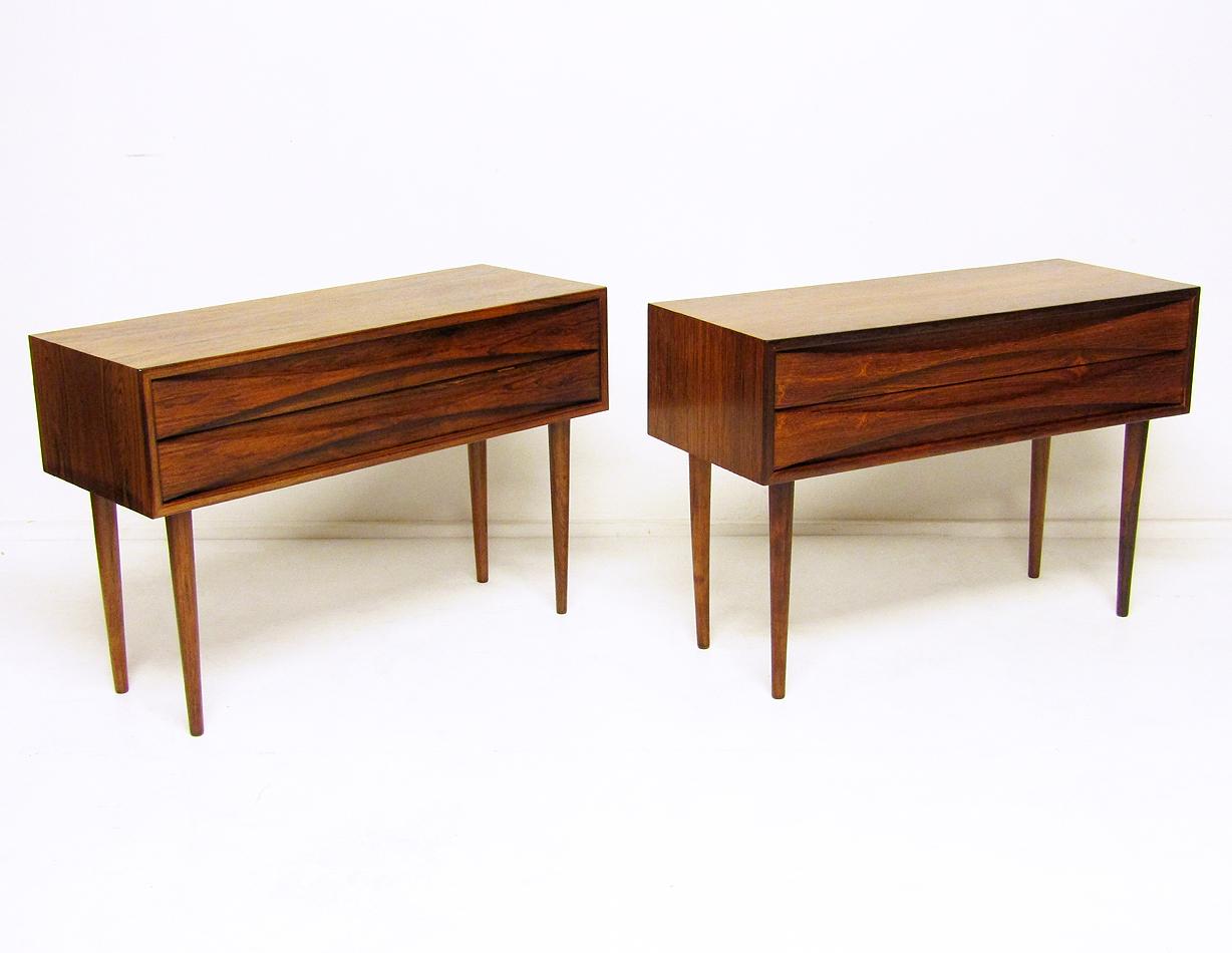 A pair of sleek 1960s Danish rosewood side cabinets by Niels Clausen for NC Möbler.

Similar to Arne Vodder's designs, they have gracefully sculpted drawers and are veneered in beautifully grained Rio rosewood.

They rest on tapered, solid