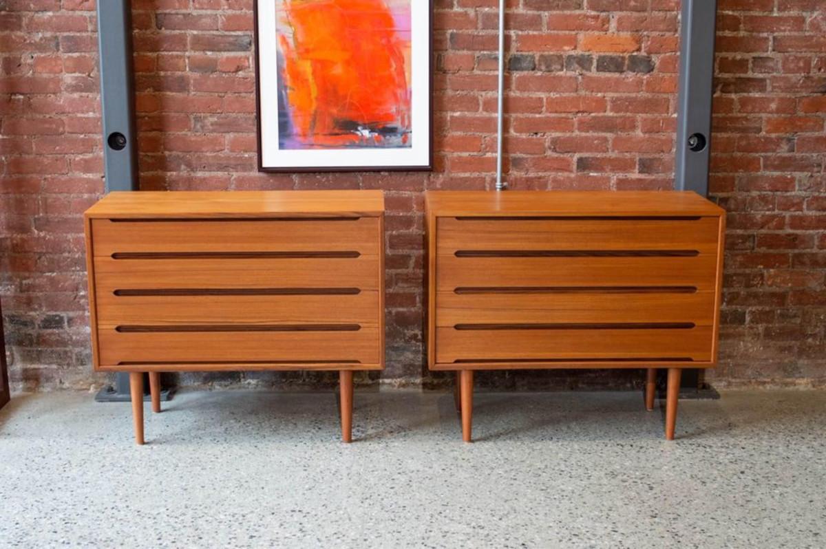 Introducing a stunning duo of mid-century teak dressers, expertly crafted in Denmark during the 1960s. Their standout feature lies in the distinct and minimalist drawer pull design, symmetrically crafted to exude both charm and functionality.