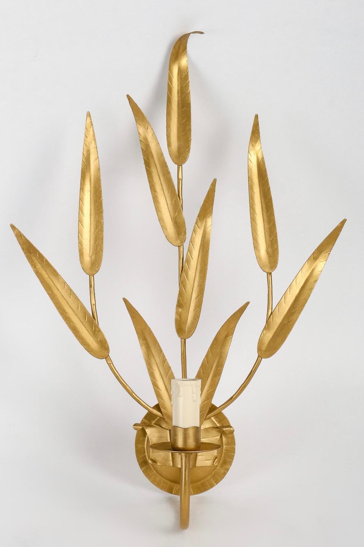 Pair of 1960's 'Foliage' sconces by Maison FlorArt composed of gilt iron foliage.                         
Composed of a round wall support on which rests 3 fine upward-moving stems embellished with foliage.
On the lower part of the wall base, an