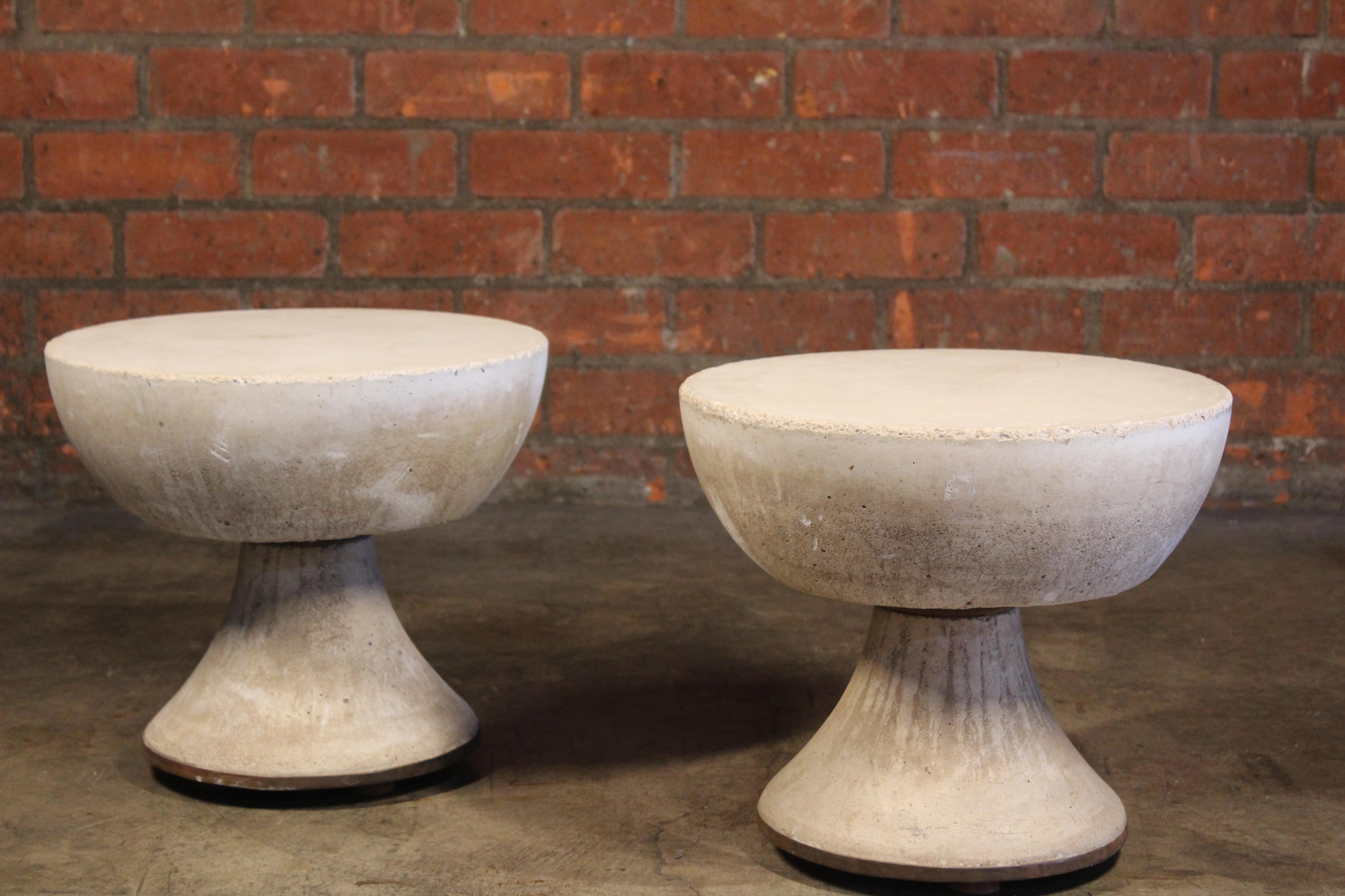Pair of cast-concrete side tables from France, 1960s. These heavy durable tables are suitable for indoor or outdoor use. Made of cast concrete with steel feet and a brass detailed bottom edge. Sold as a pair.