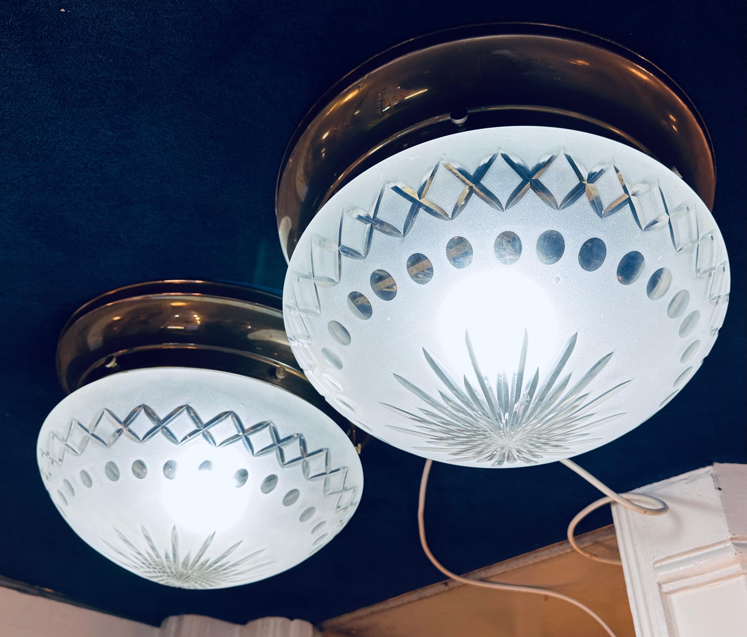 Pair of 1960s French frosted and cut glass flush mount ceiling lights which could also be used as wall lights. The heavy thick frosted glass shade features cut glass star shaped design in the centre, rows of circles in the middle and a triangular