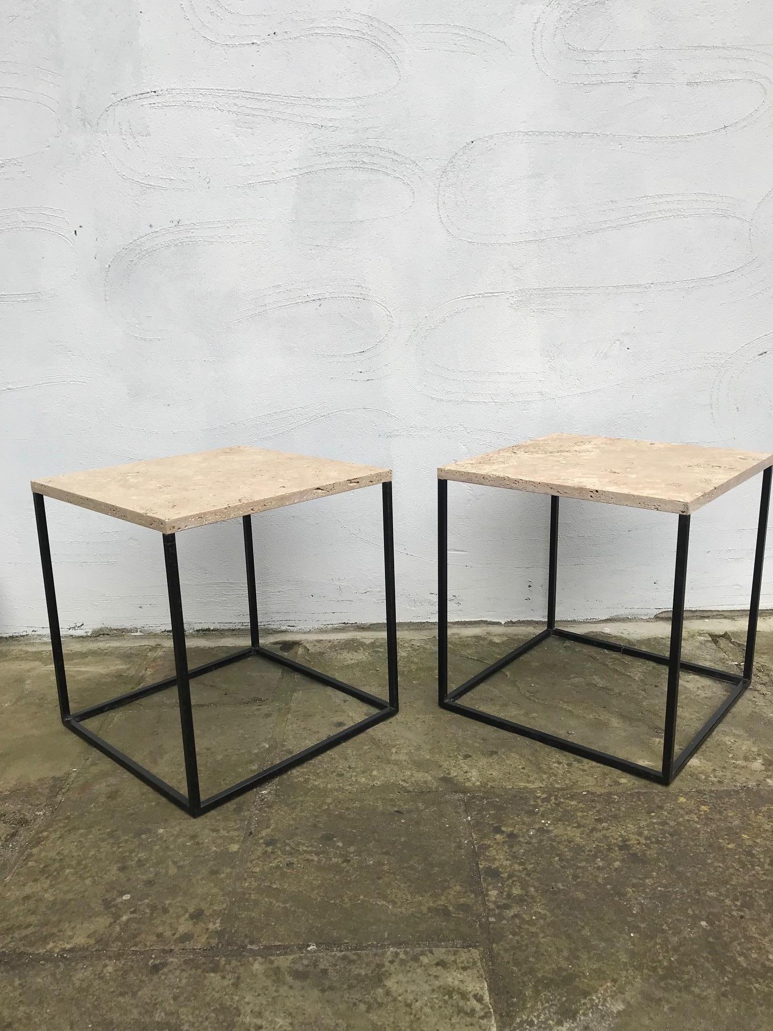 A pair of French 1960s black metal and travertine topped small side tables. Cool and restrained in style, perfect side tables next to a sofa or bedside tables. The travertine is unfilled. Good period French 1960s design.