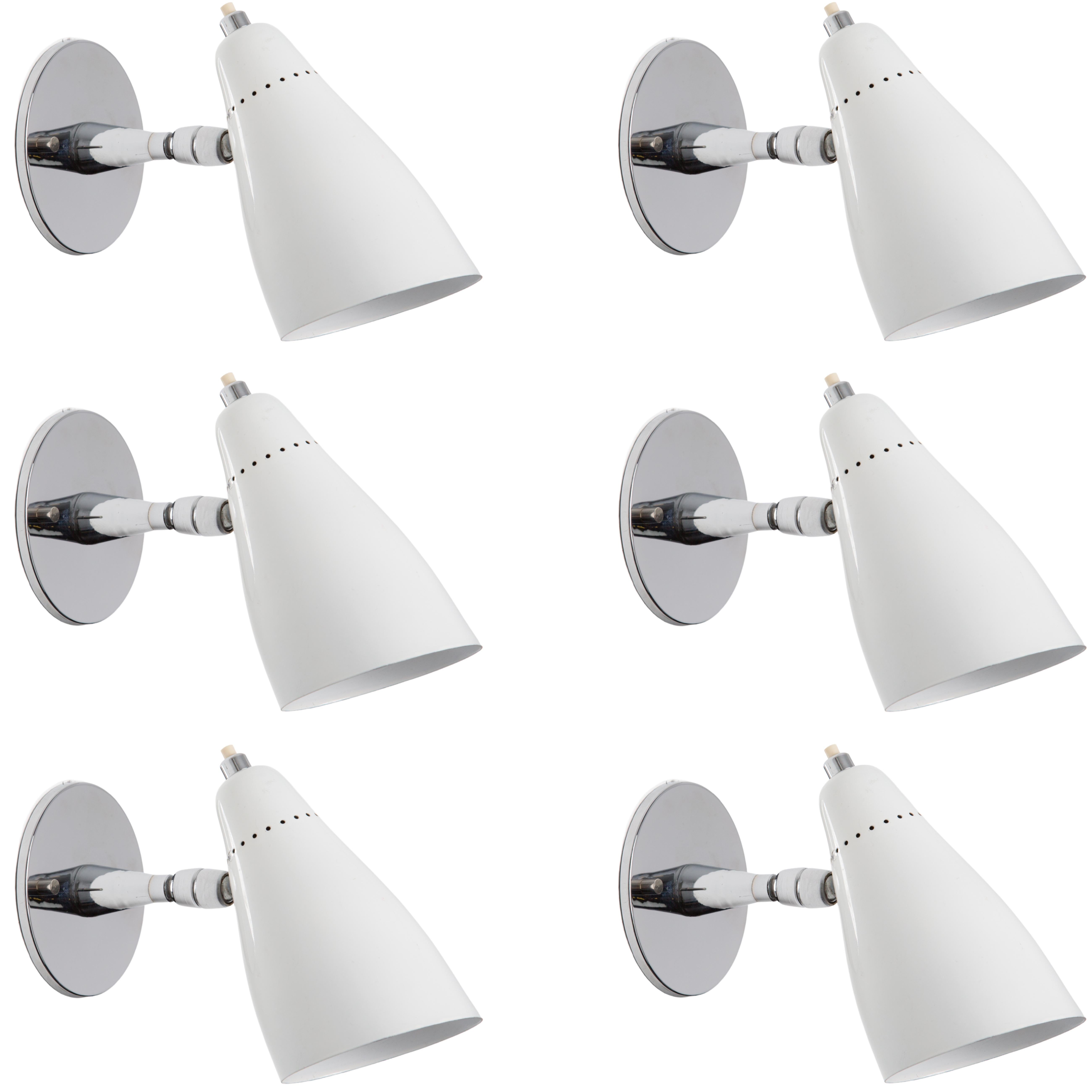 Pair of 1960s Giuseppe Ostuni Model #101 white articulating sconces for O-Luce. Executed in polished chrome and a white painted perforated aluminum shade. Sconces pivot up/down and left/right. An incredibly clean and refined design by one of the