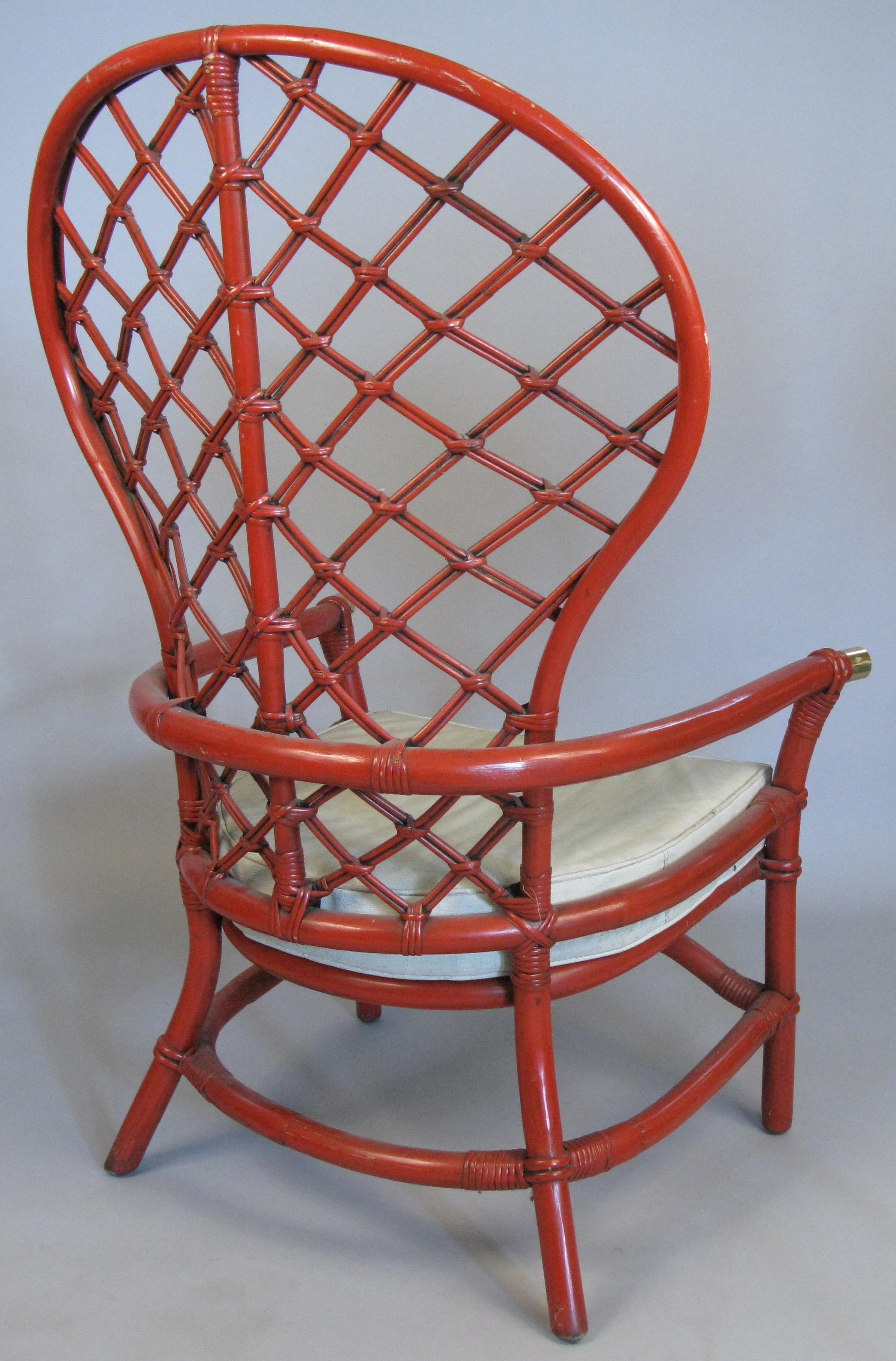 A beautiful pair of vintage 1960s large high back rattan armchairs, with woven lattice design back and brass caps on the armrests. In their original Pompeii red painted finish and vinyl upholstered seat cushions. Great scale and proportions.
