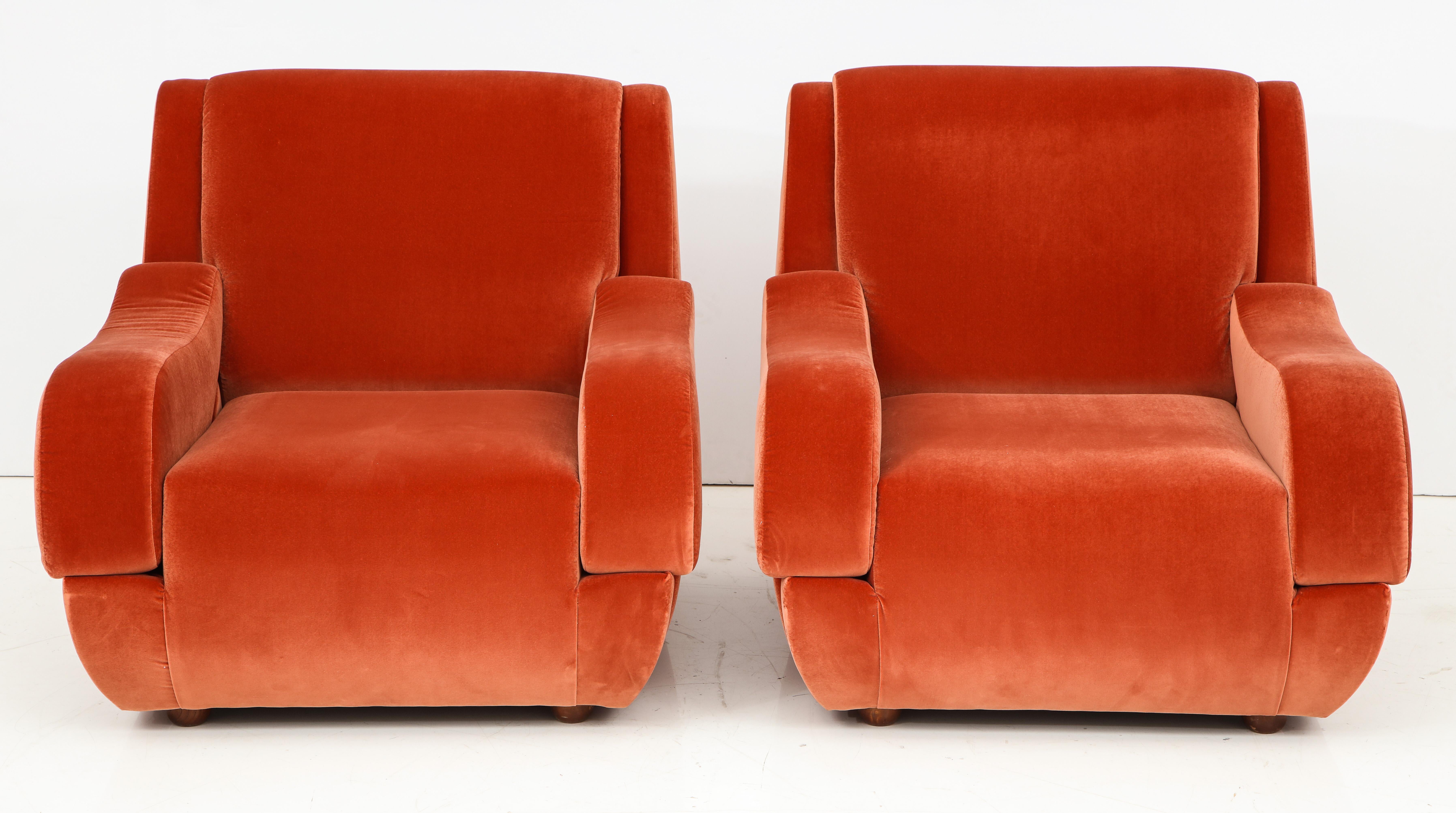 Elegant pair of vintage Italian lounge chairs with sculptural midcentury Italian design in the style of Ico Parisi. Completely restored and newly reupholstered in a Vermillion colored imported soft velvet. Comfortable and sturdy. This pair of