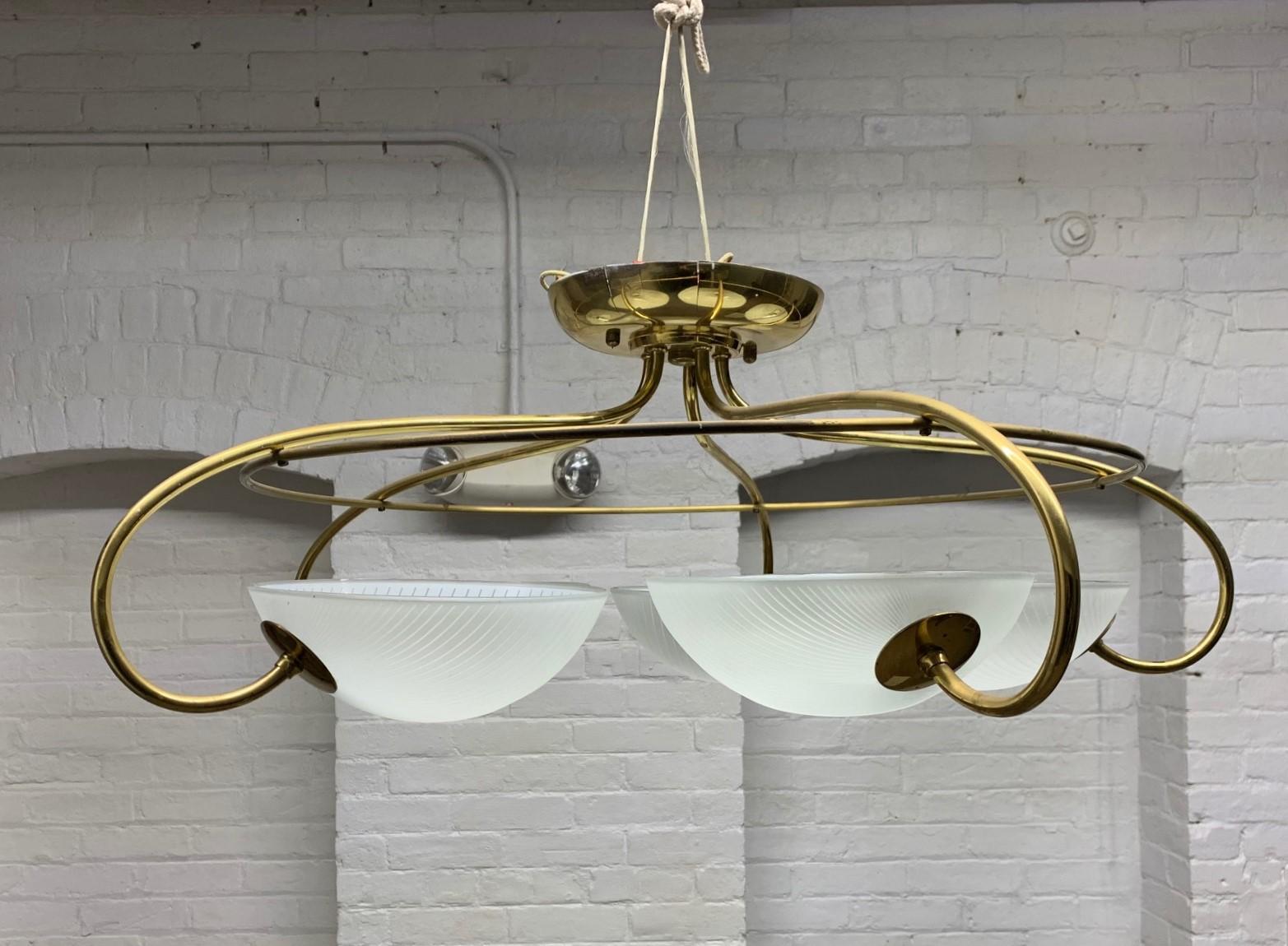 Pair of 1960s, Mid-Century Modern, Italian brass and glass light fixture / chandelier. Has five glass globes with a curved brass structural frame.