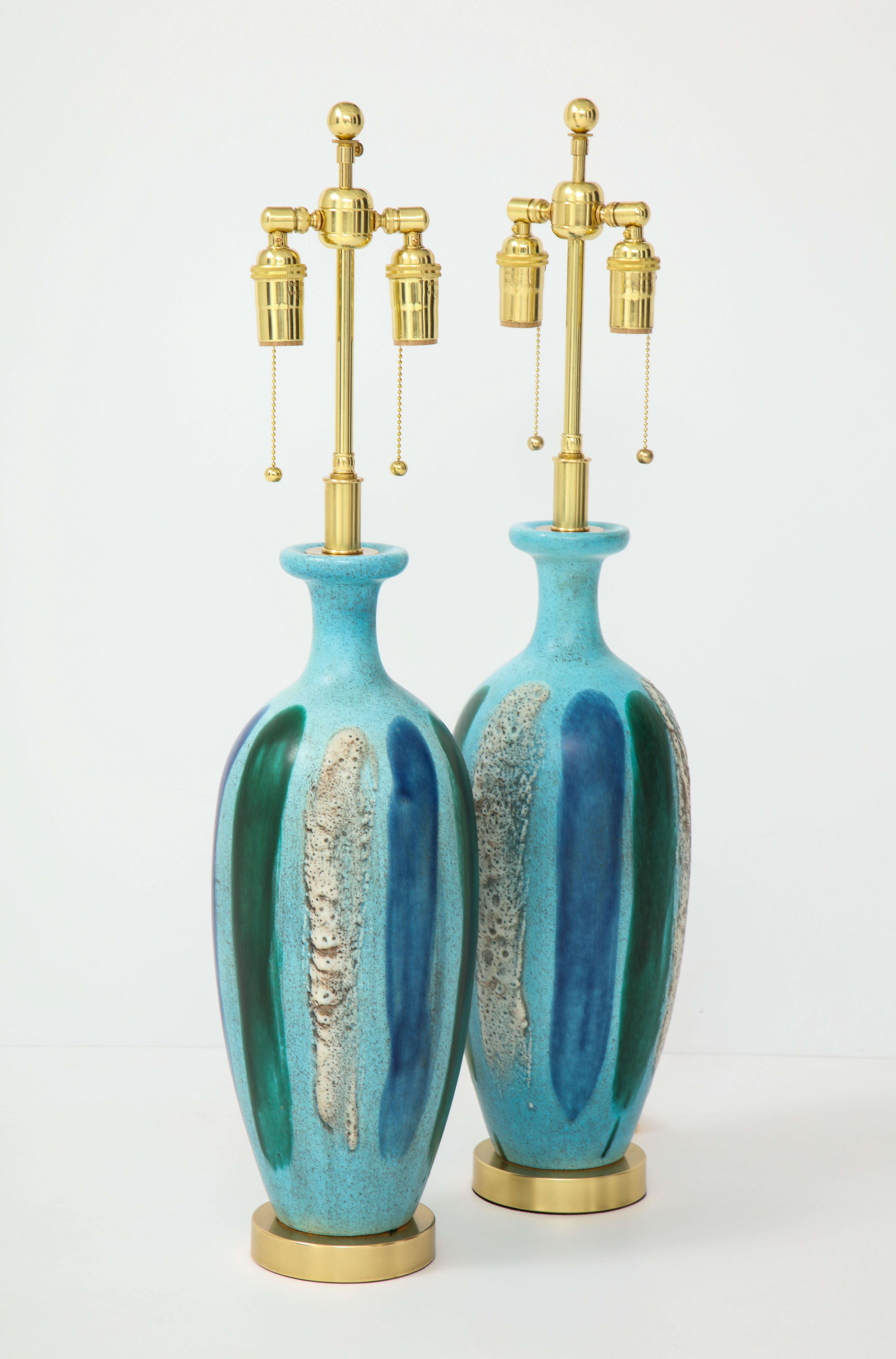 Pair of 1960s Italian ceramic lamps.
The lamps are mounted on polished brass bases and they have
been newly rewired with brass double clusters.