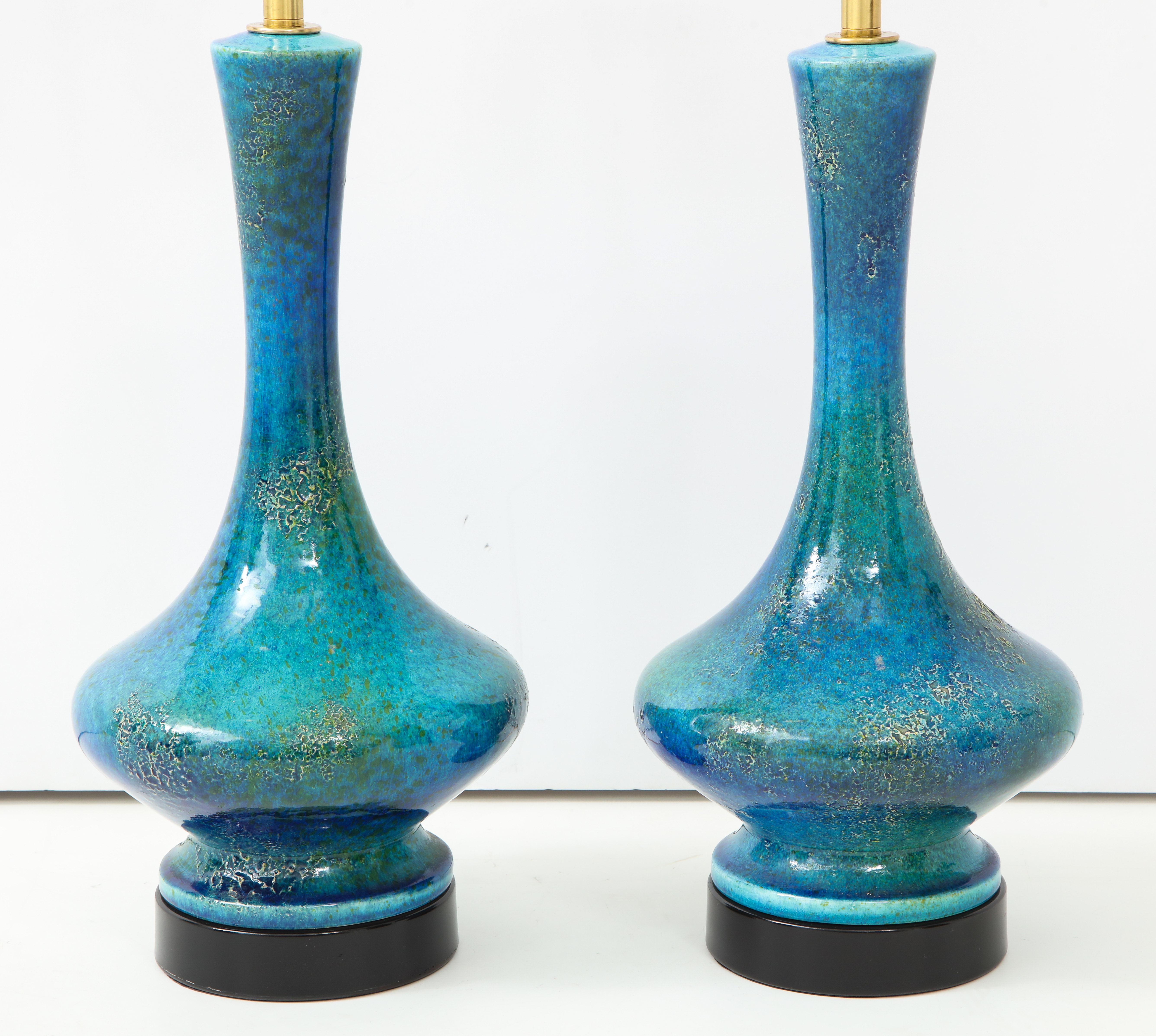 Pair of ceramic lamps with beautiful textured glazed finish.
The lamps have been newly rewired with polished brass double clusters.