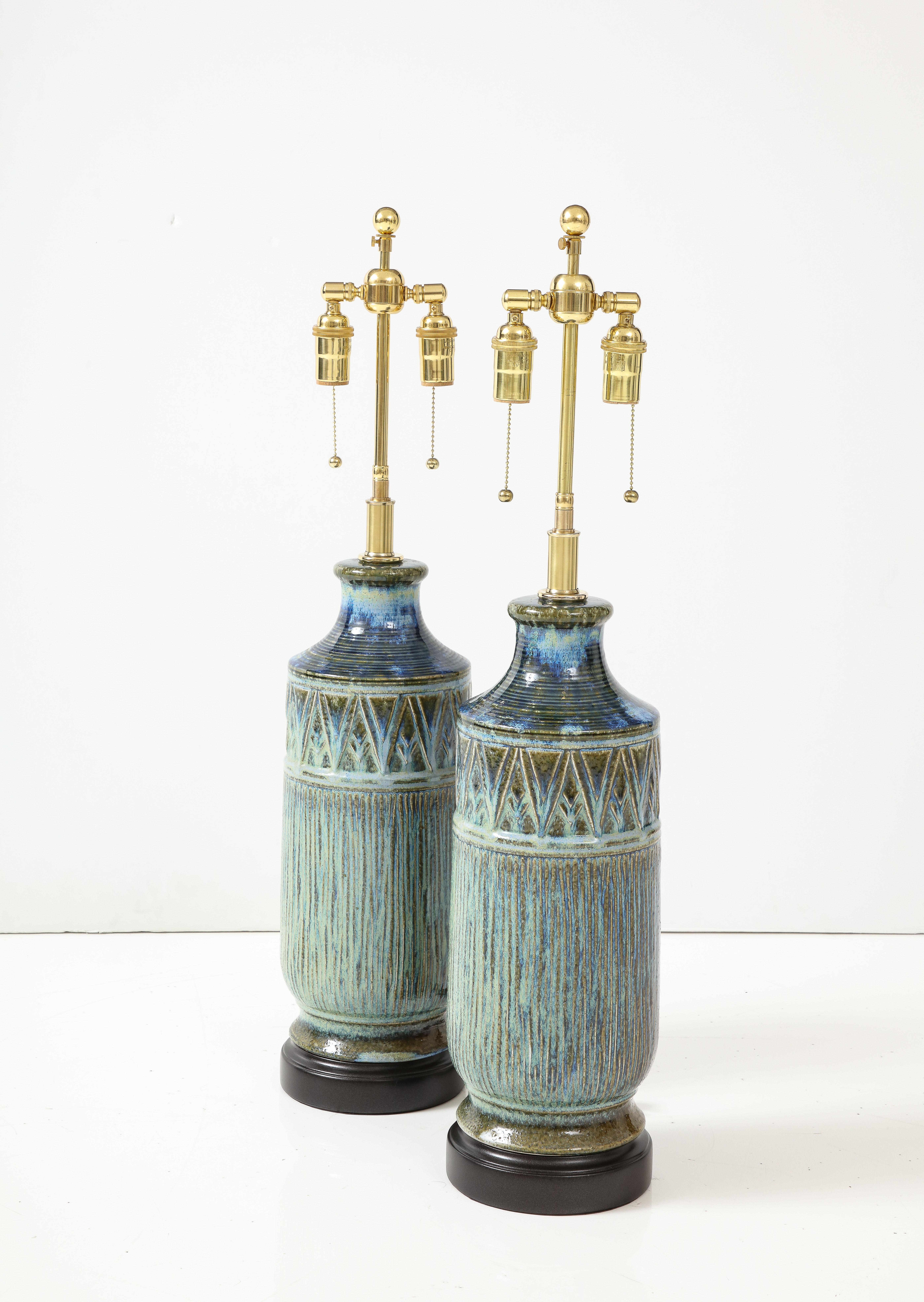 Pair of 1960's Italian ceramic lamps with a textured relief design.
The lamps have been Newly rewired with adjustable polished brass double clusters that take standard size light bulbs and silk rayon cords.
Each socket takes up to 60 Watts / 120
