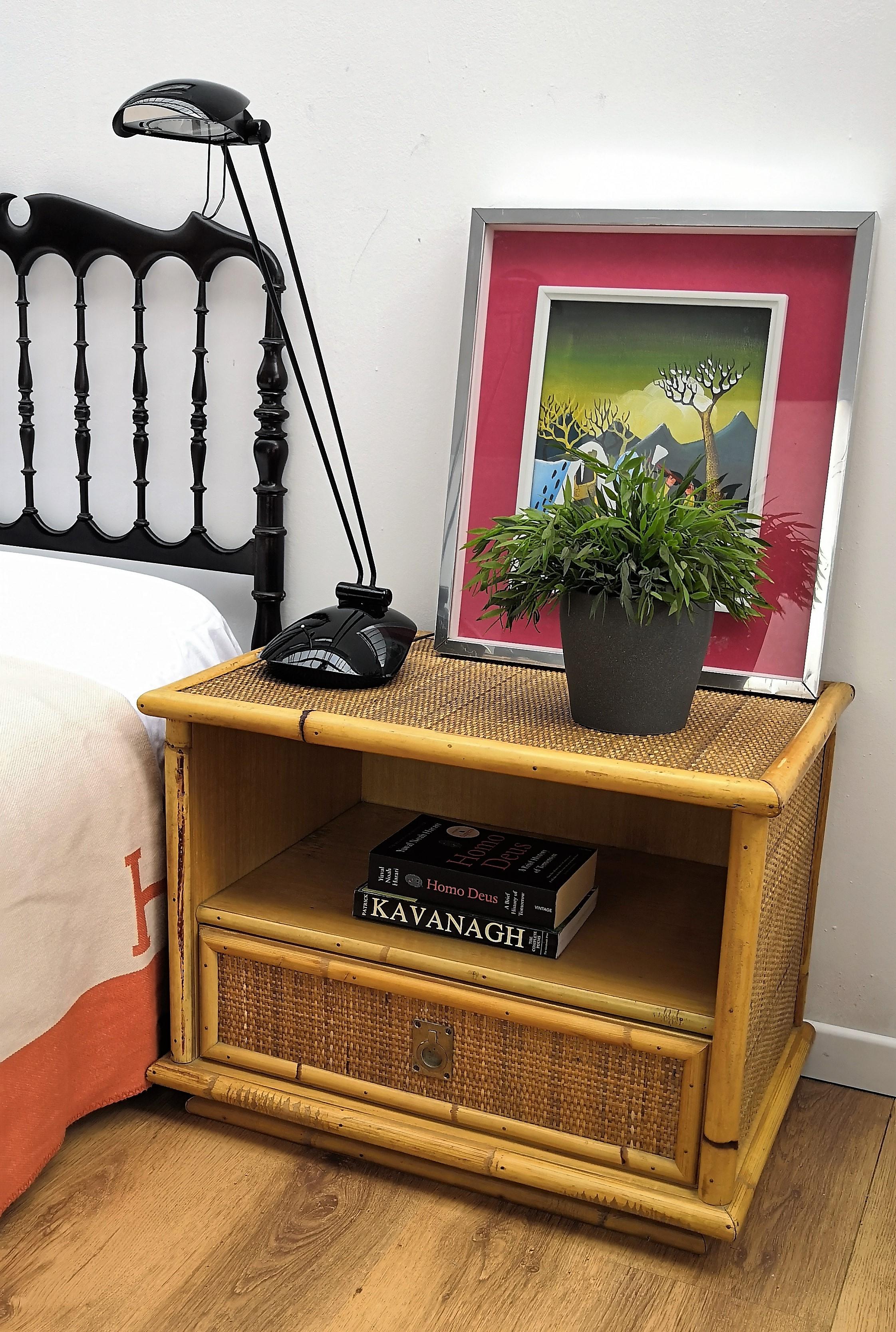 Beautiful pair of 1960s Italian Mid-Century Modern nightstands in bamboo and rattan with brass handles with one-drawer, from renowed Dal Vera manufacturer. The organic beauty of the woven materials is timeless and Classic, making bamboo and rattan