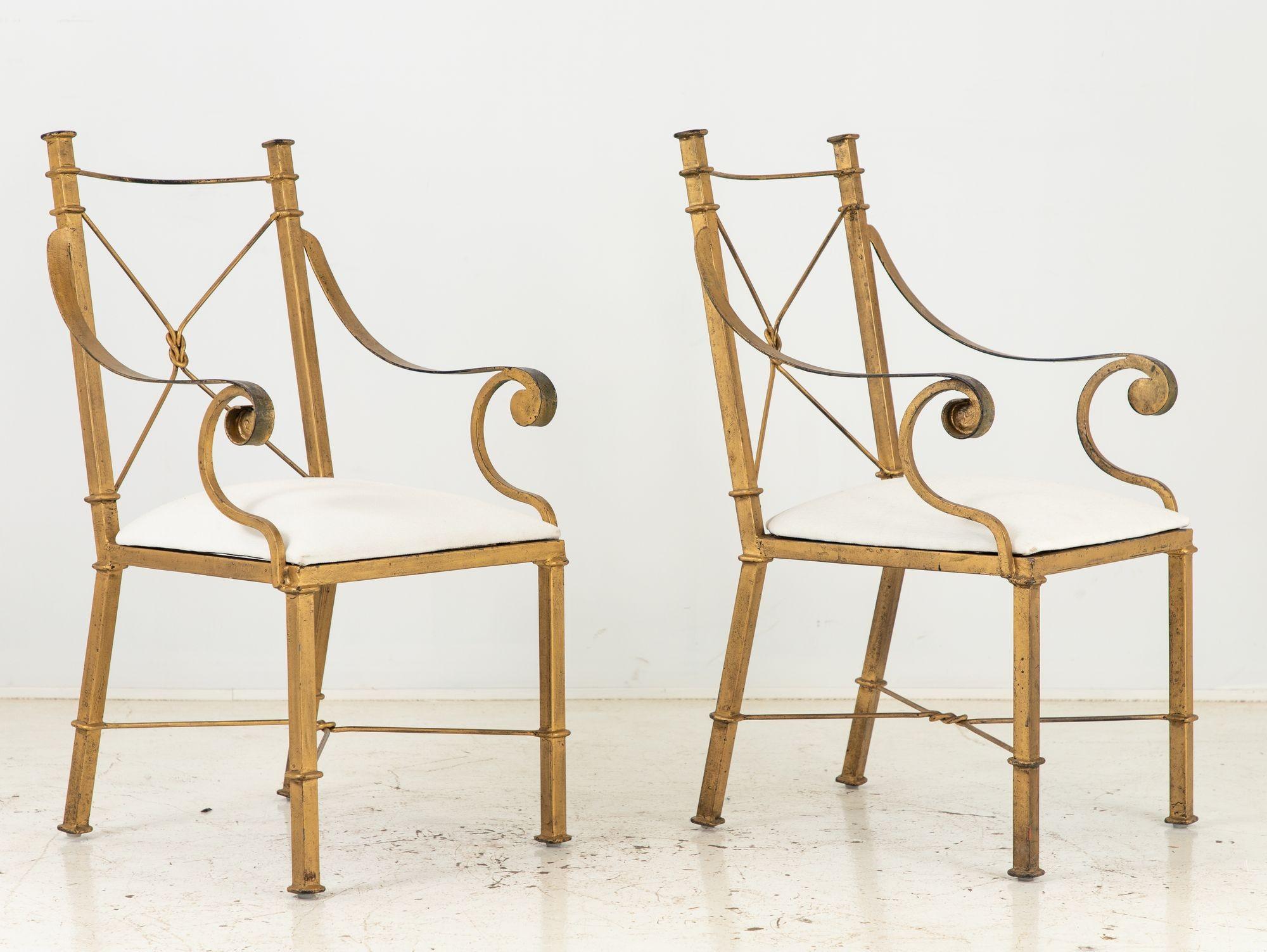 Indulge in the opulence of Italian design with this exquisite pair of gilt metal elbow or armchairs from the 1960s. The intricately crafted gilt metal frames showcase the remarkable artistry of the era, while the gracefully curved lines exude