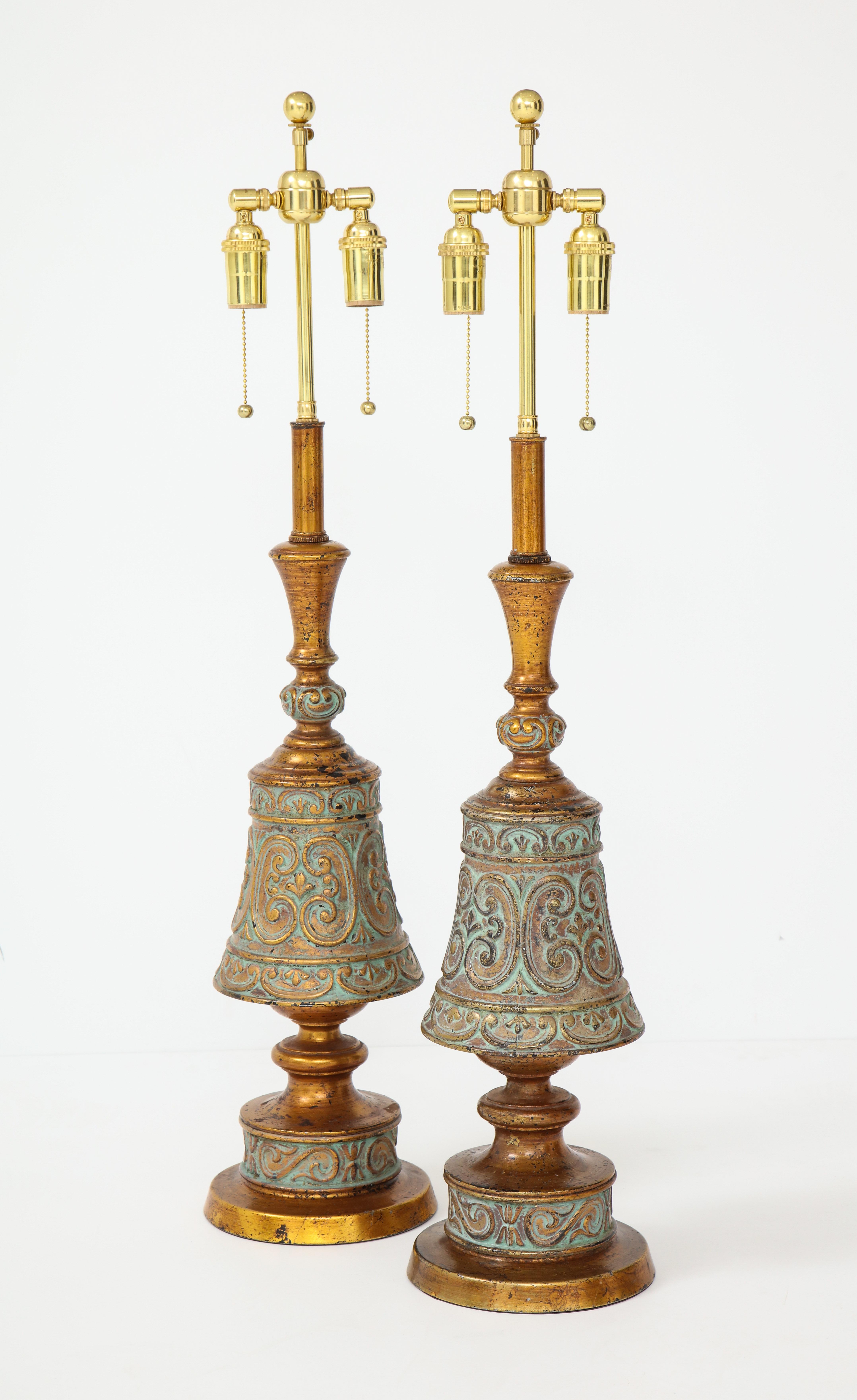 Pair of 1960s Italian Hollywood Regency style lamps.
The beautifully decorated gold and teal metal lamp bodies
have been newly rewired with polished brass double clusters.