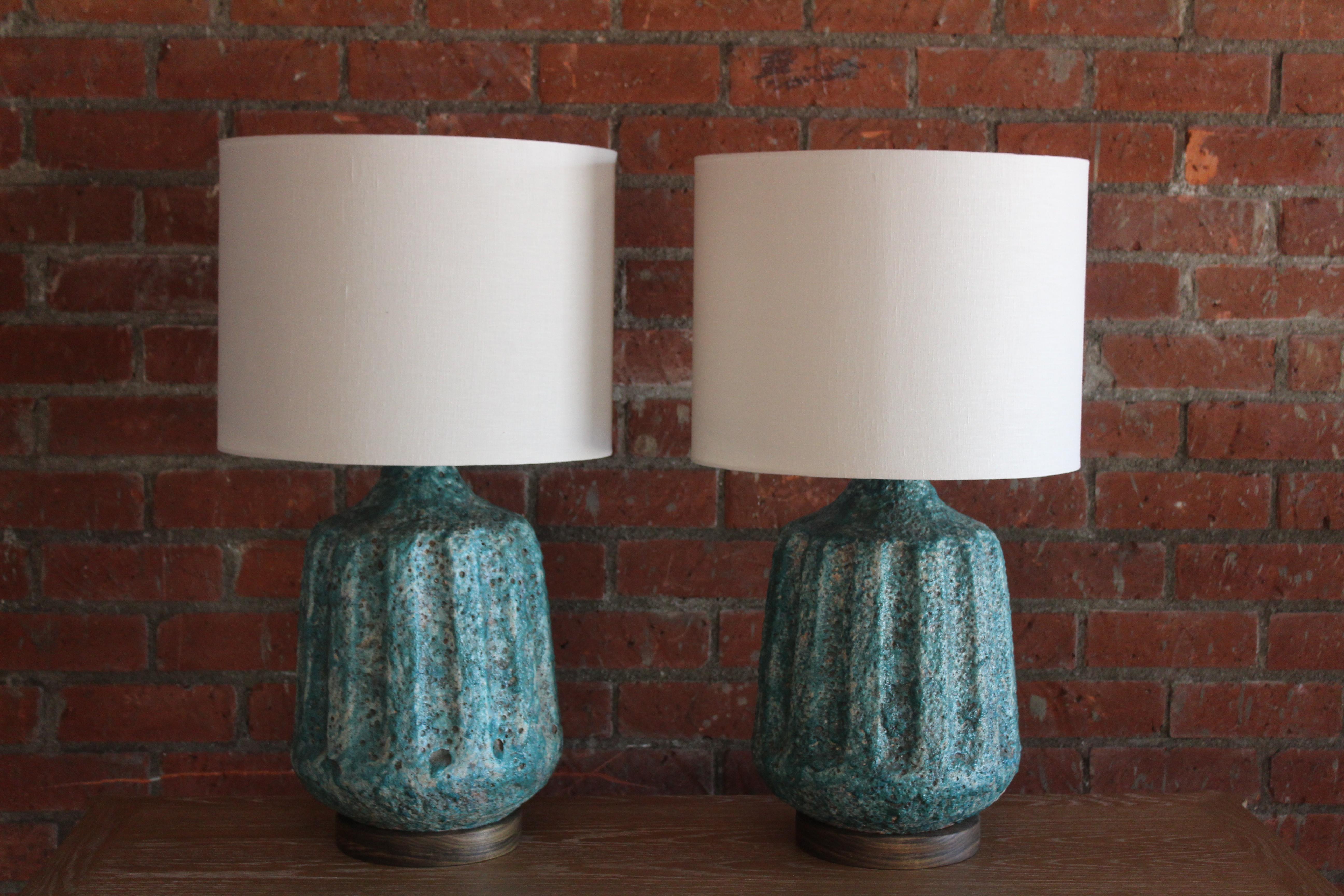 Pair of vintage 1960s Italian lava glazed ceramic lamps. Newly rewired and fitted with custom made shades in Belgian linen. New bases in walnut. Sold as a pair. 
Measures: 15