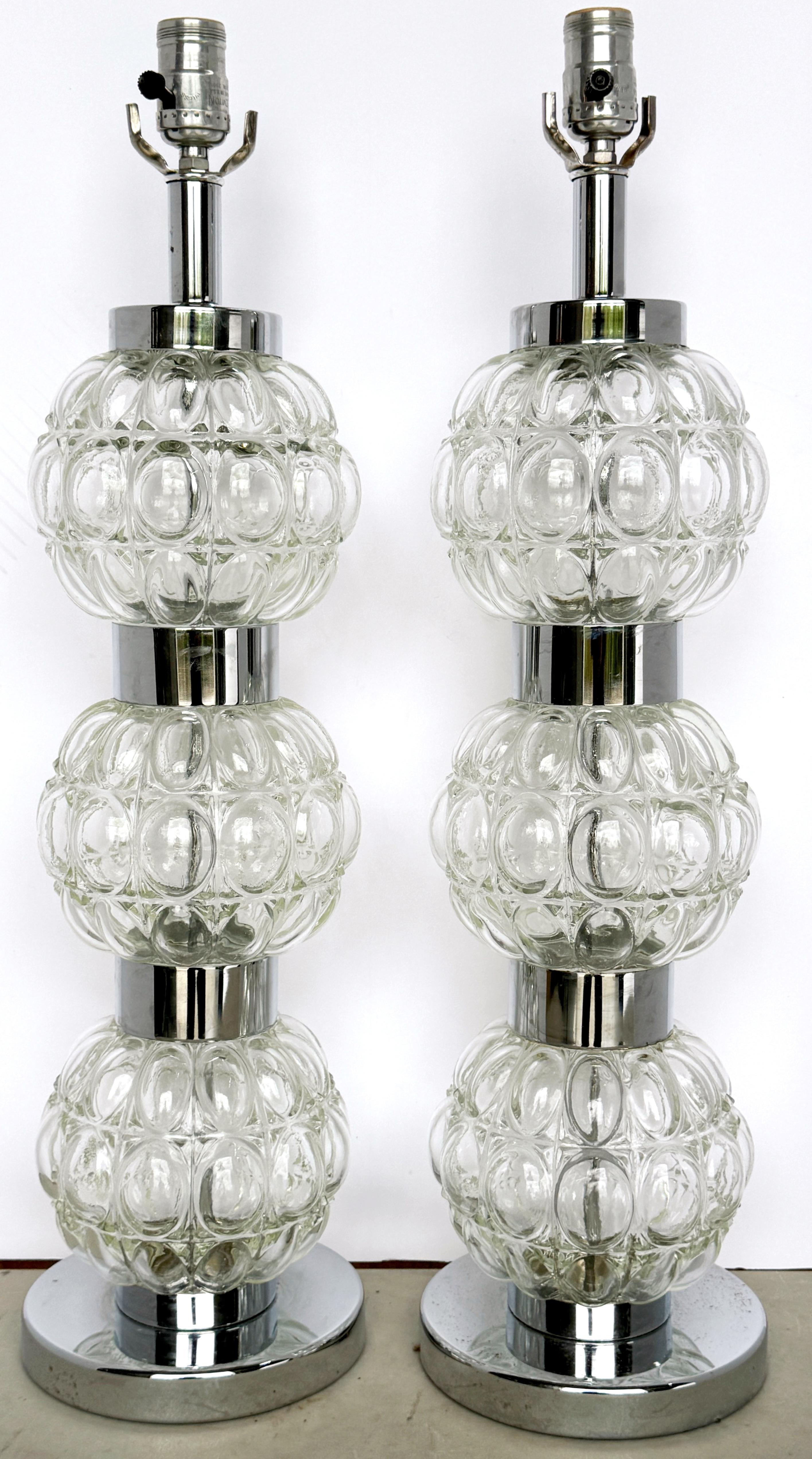 Pair of 1960s Italian MOD/ Space Age  Murano Glass Sphere Column Lamps 

We are please to offer this unique duo, a pair of 1960s Italian MOD/Space Age Murano glass sphere column lamps. These stunning pieces stand  23 inches in height to the top of