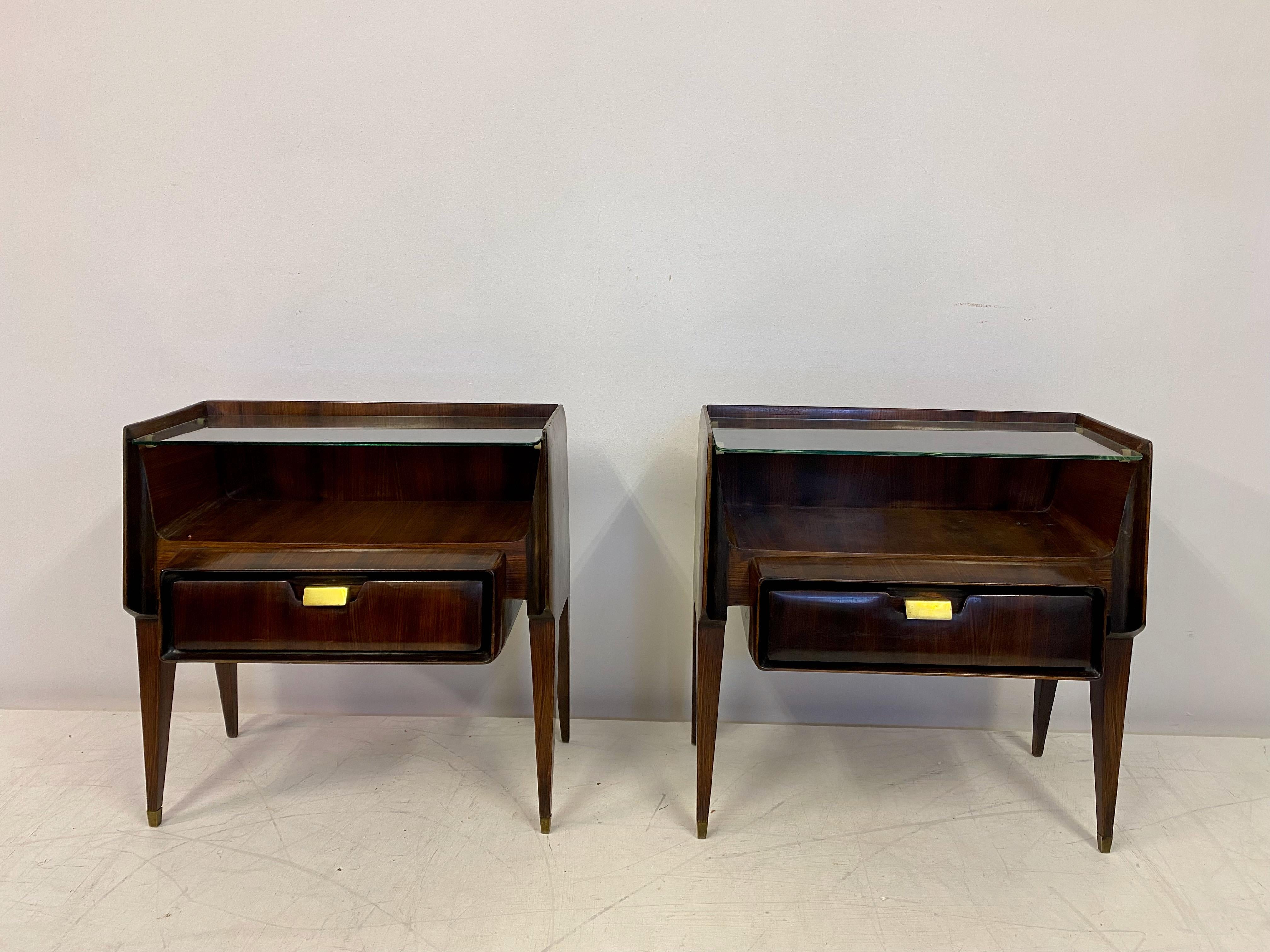 Pair of bedside tables

Rosewood frame

Glass top shelf

Brass feet and handles

Price includes refinishing

1960s Italian.