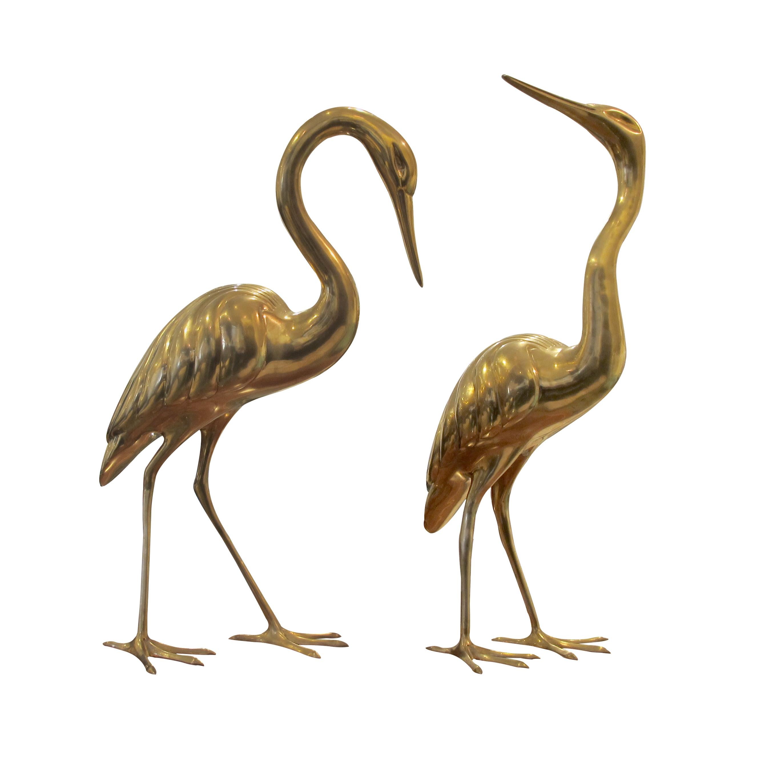 Pair of 1960s large brass herons which are very realistic with elegant smooth curves and postures. The herons are free standing and well-balanced. In excellent vintage condition with a matte shine but can be polished to an even higher shine. The